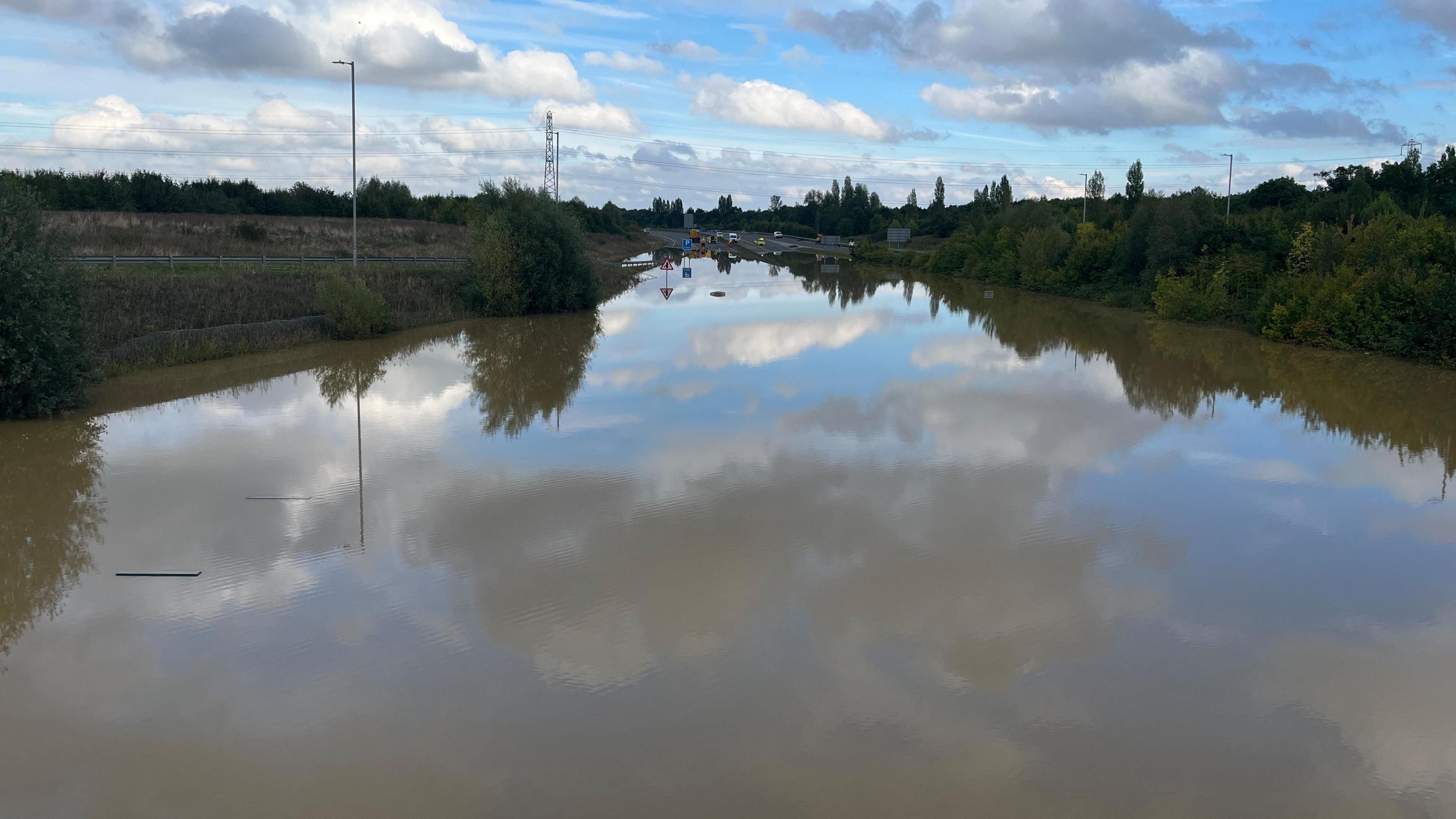 The water levels on the A421 were so high before that you can only just see the top of the roadside pumping station 