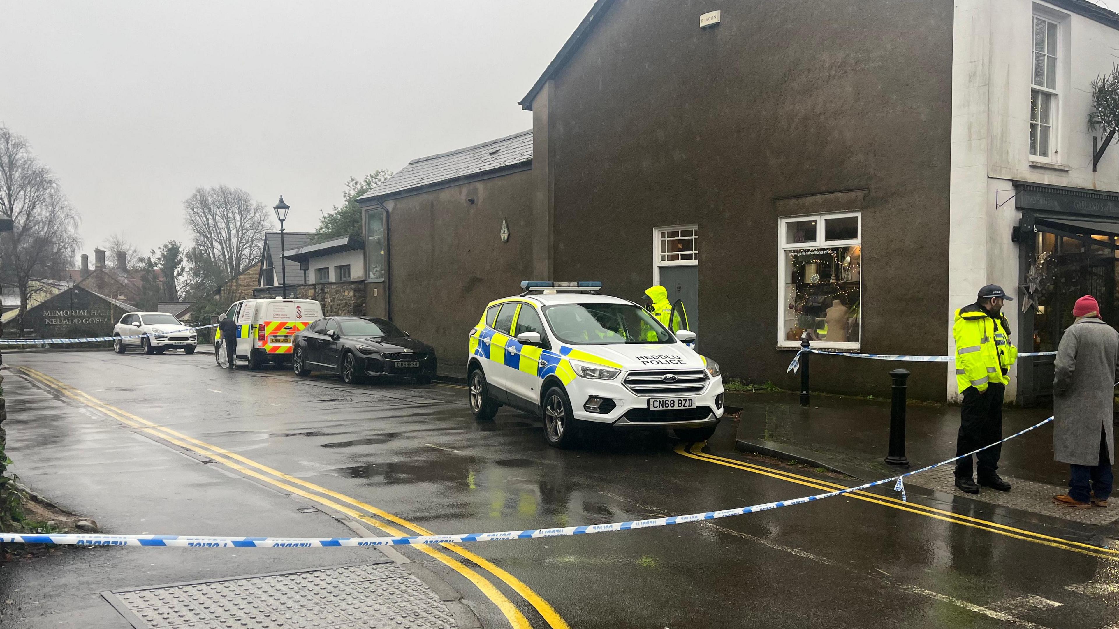 Police officers, vehicles and tape in Chapel Street, Llandaff, on Christmas Eve 2023