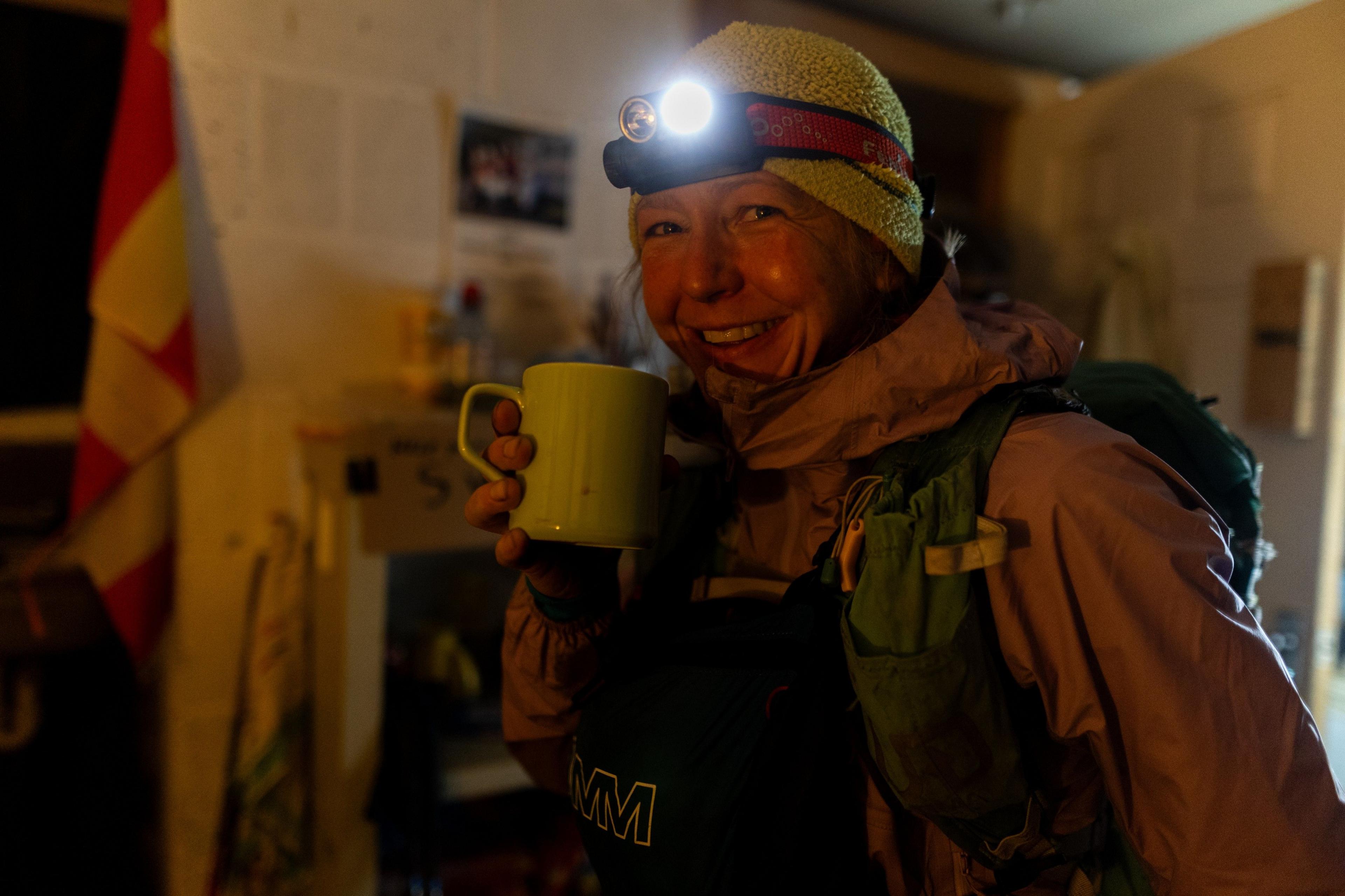 Gossage, wearing a purple coat, yellow hat and a torch on her head, stops for a hot drink at one of the checkpoints along the route. 