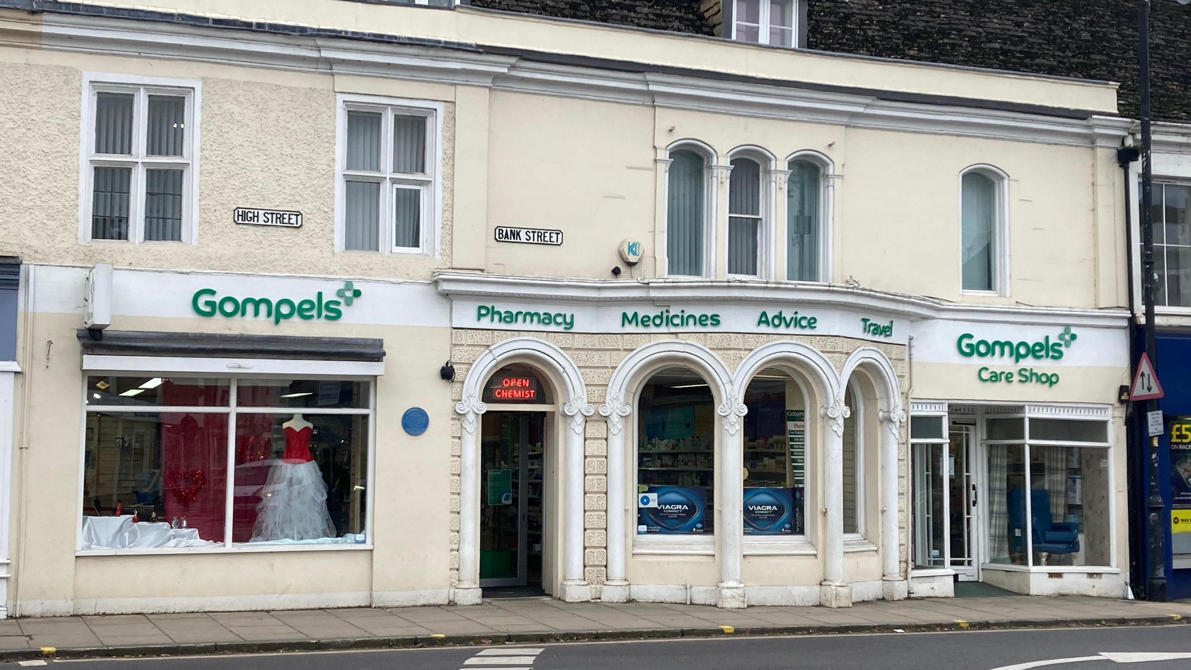 The front of Gompels pharmacy next to a road in Melksham