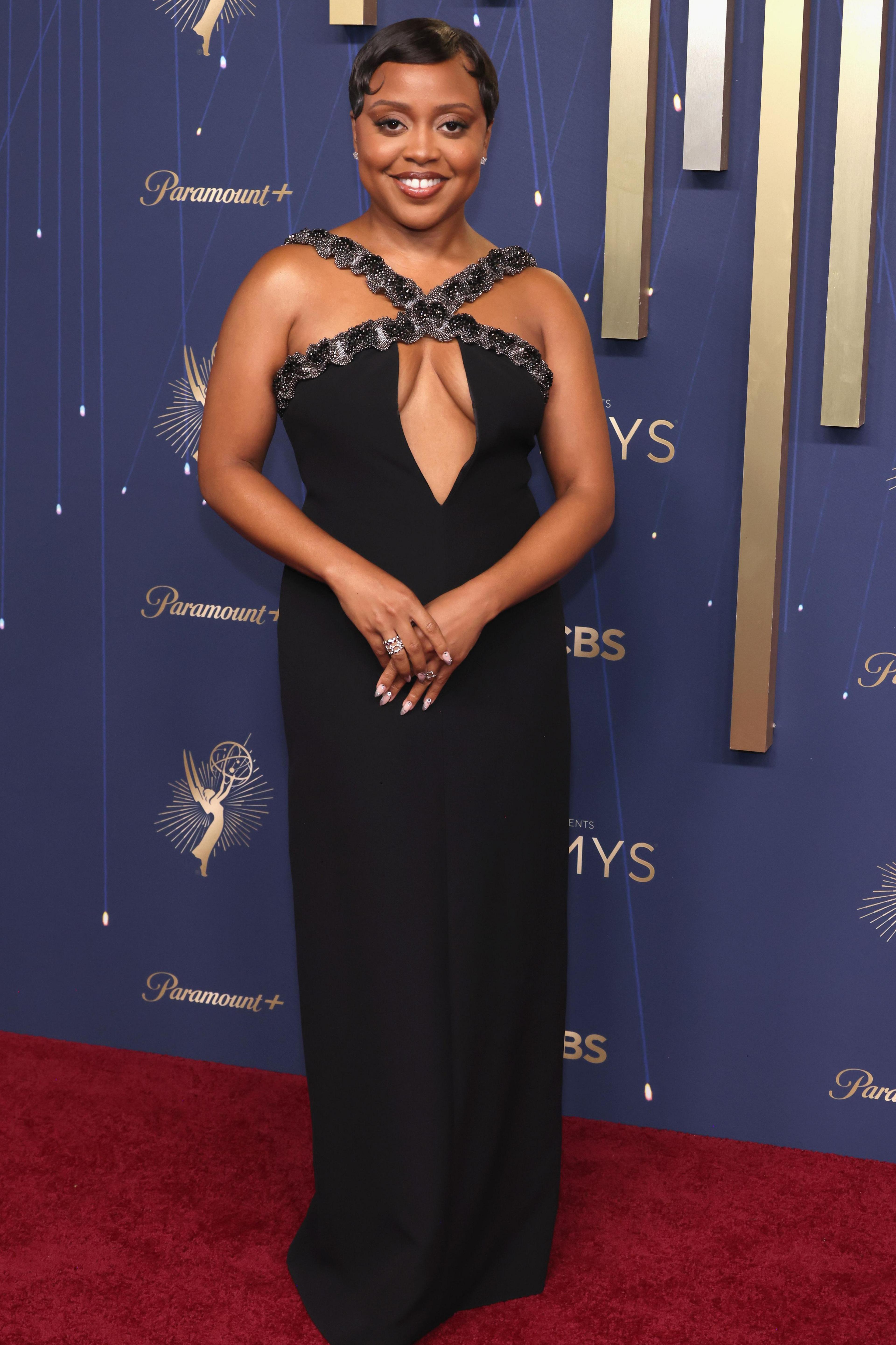 Actress Quinta Brunson wears a black halter gown with a dramatic keyhole cut out in the centre as she poses for photos at the 77th Primetime Emmy Awards at the Peacock Theatre at LA Live in Los Angeles on 14 September 14