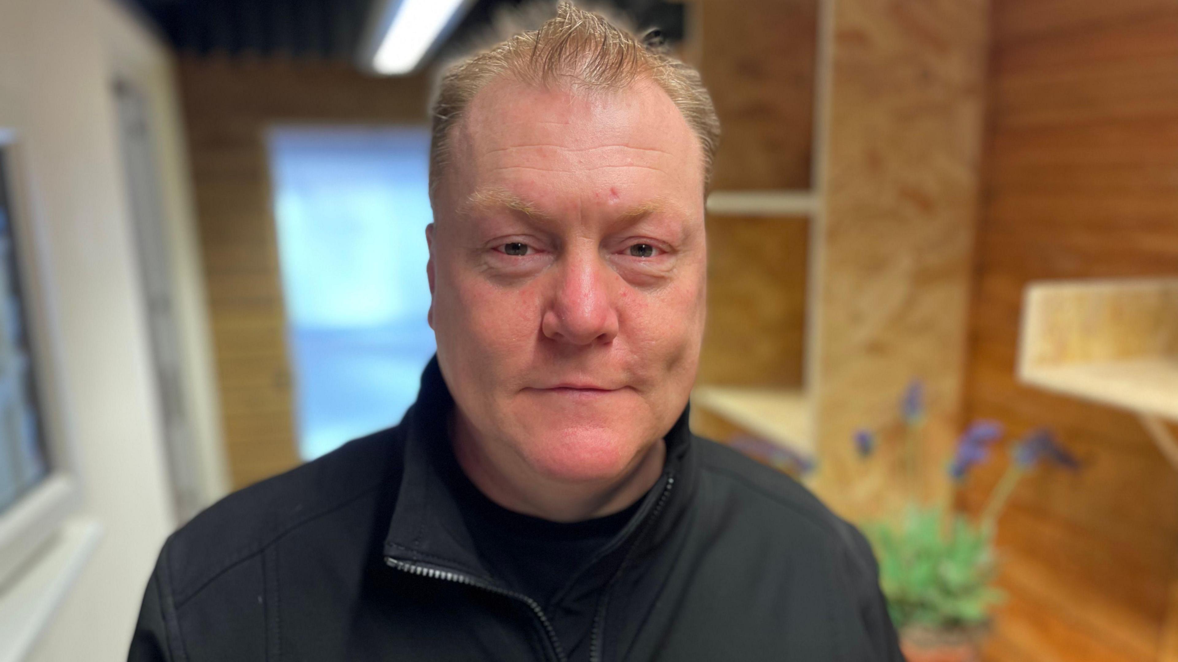 Terry is wearing a black fleece