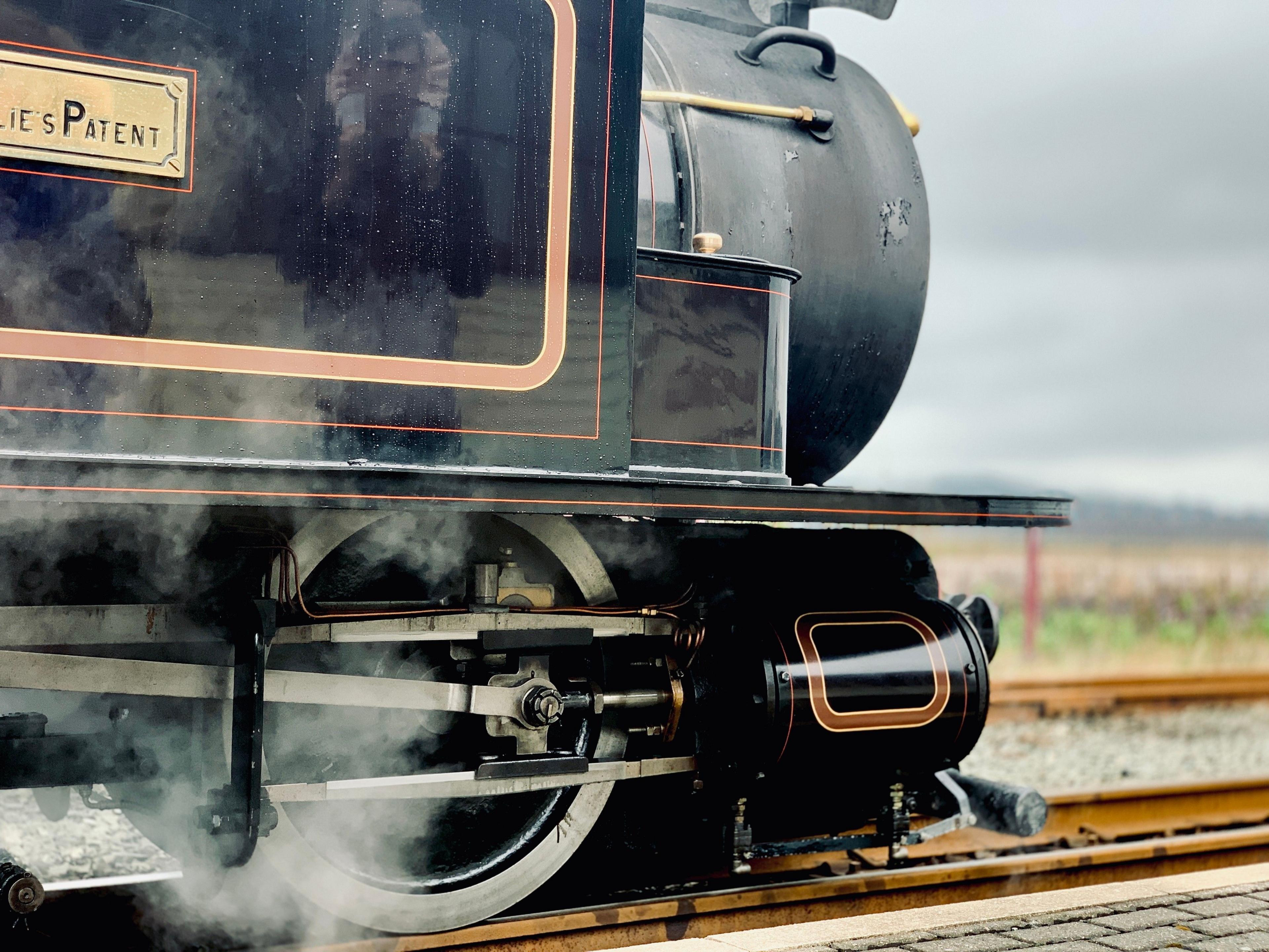 Close-up of a steam train's wheels