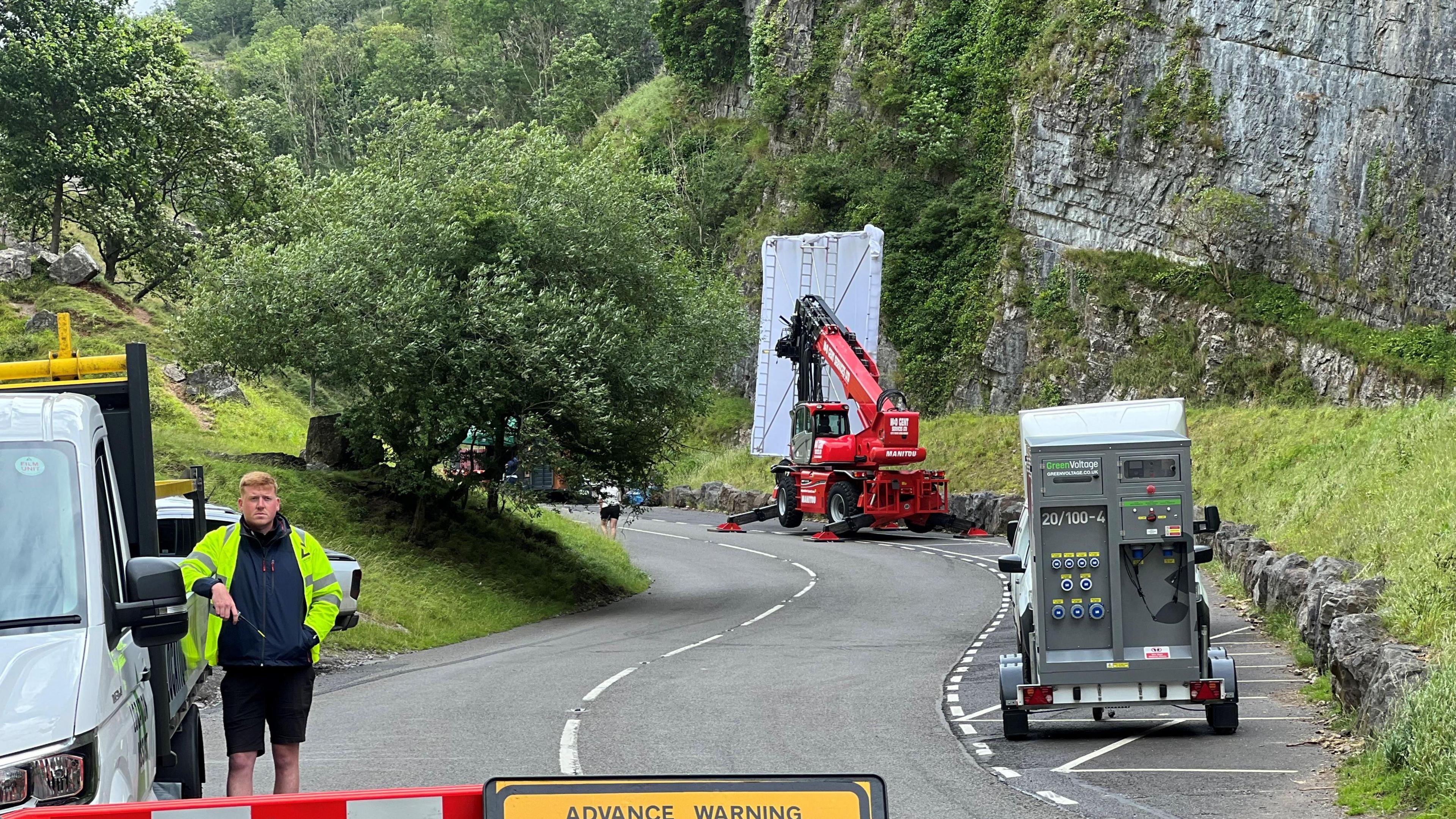 Cheddar Gorge rock face and big lorry with crane