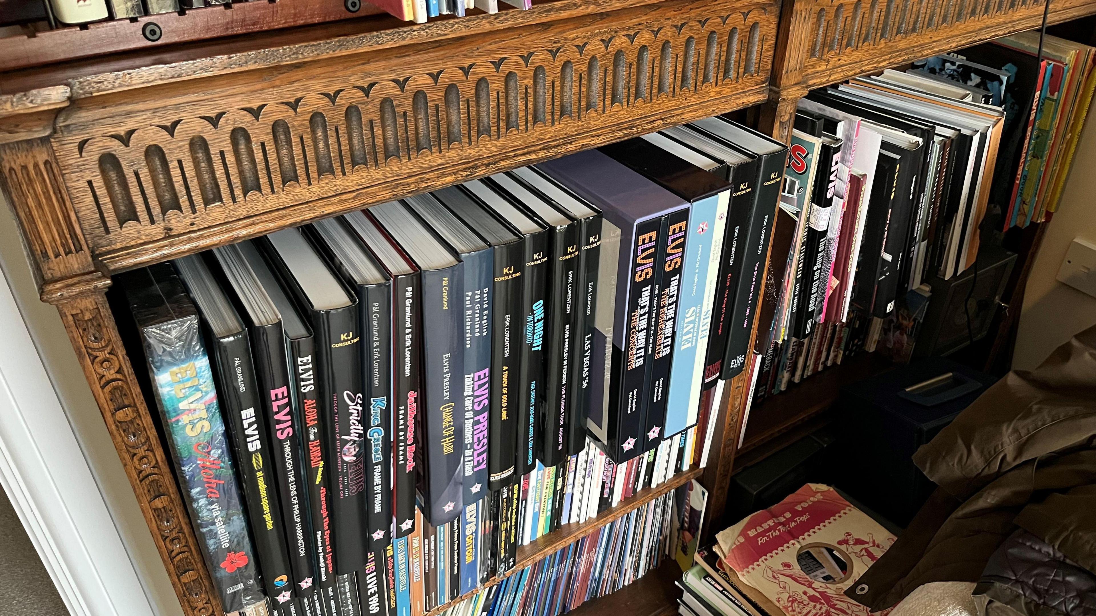 A large collection of books, the spines include Elvis in most of them. they sit in an oak style book shelf in the "Elvis room" at the home of Giles Moriarty.