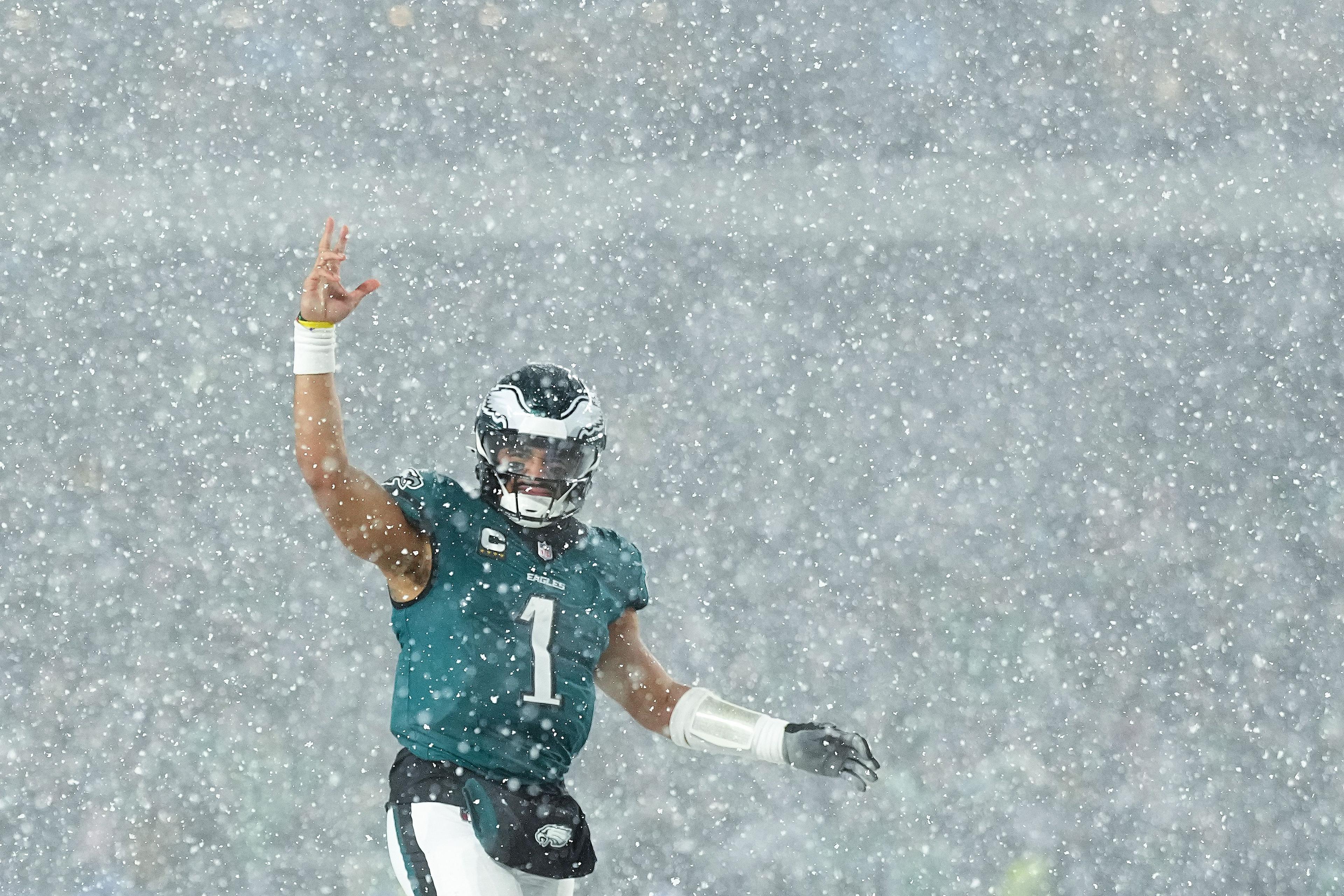 Jalen Hurts quarterback of the Philadelphia Eagles signals in the snow against the Los Angeles Rams during the fourth quarter in the NFC Divisional Playoff at Lincoln Financial Field Philadelphia