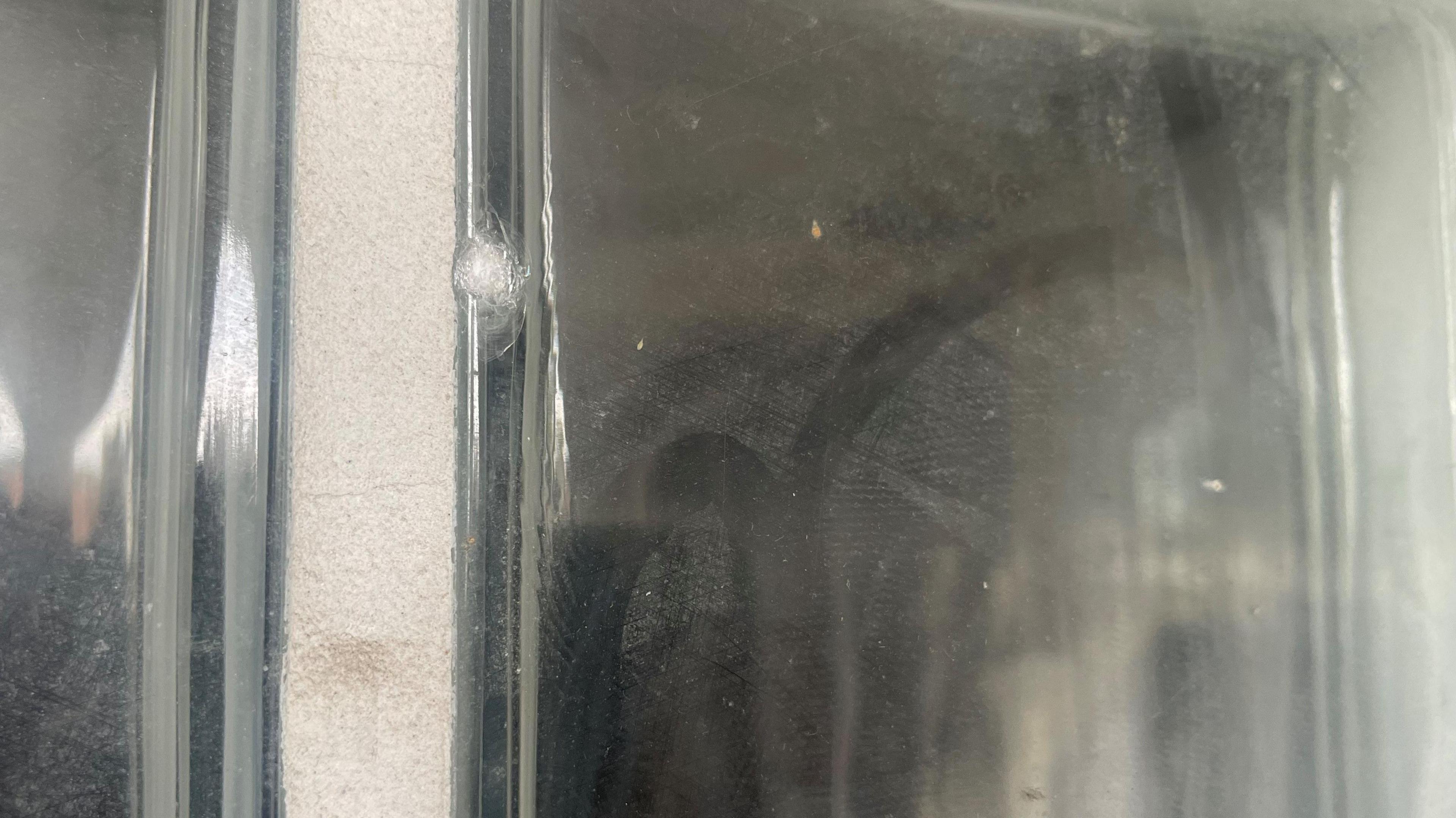 A pane of glass which has been damaged by the shooting