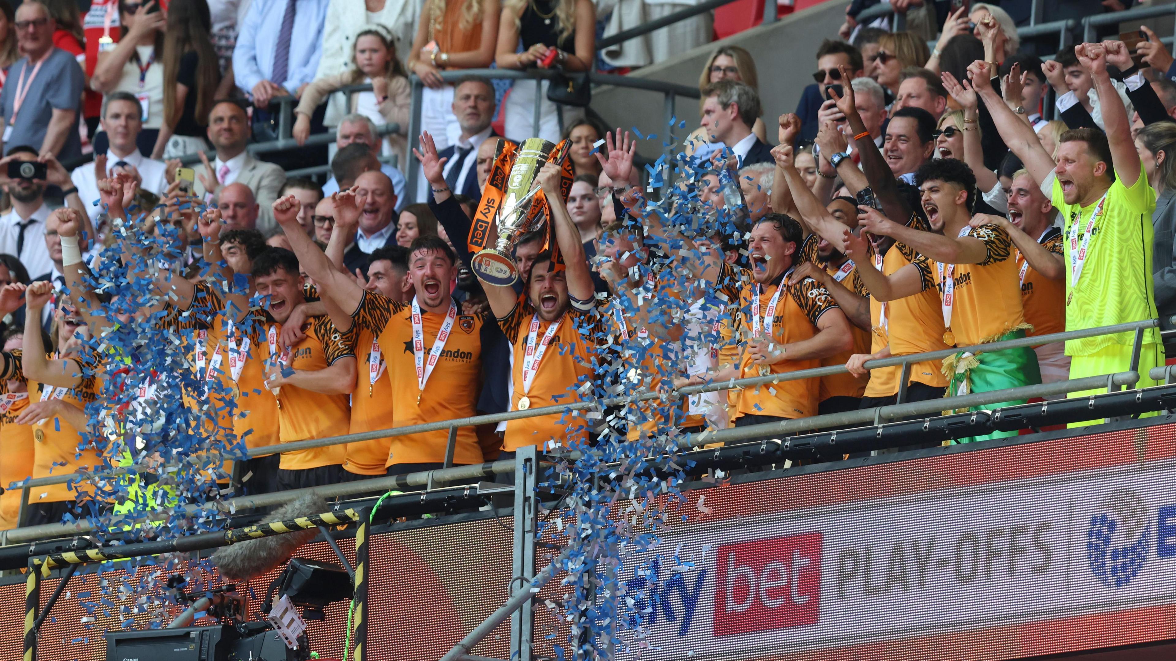 Hull players lift the trophy after winning the Championship play-offs at Wembley