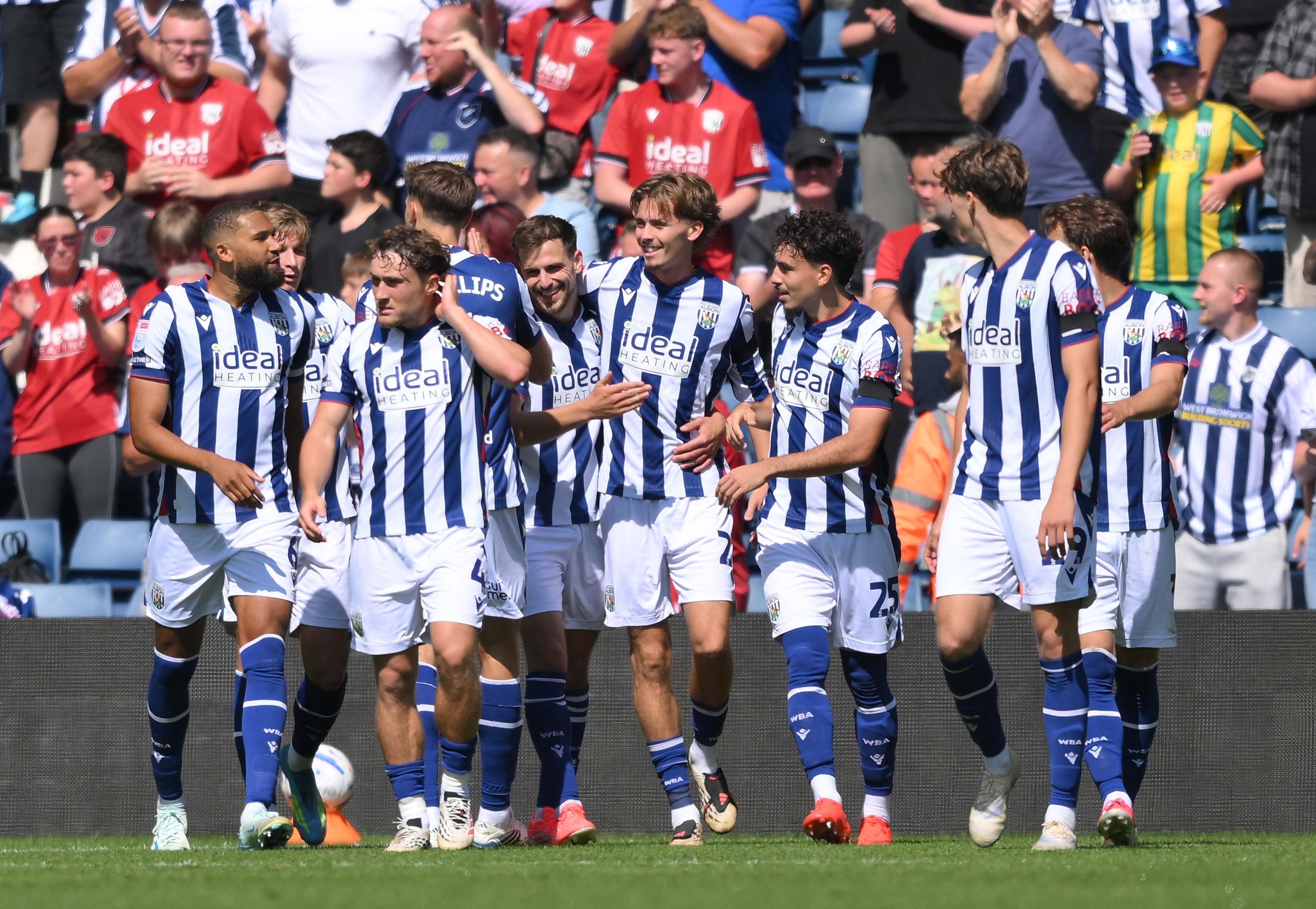 A smiling Isaac Price celebrates West Bromwich Albion's second goal with his team-mates against Burnley at The Hawthorns