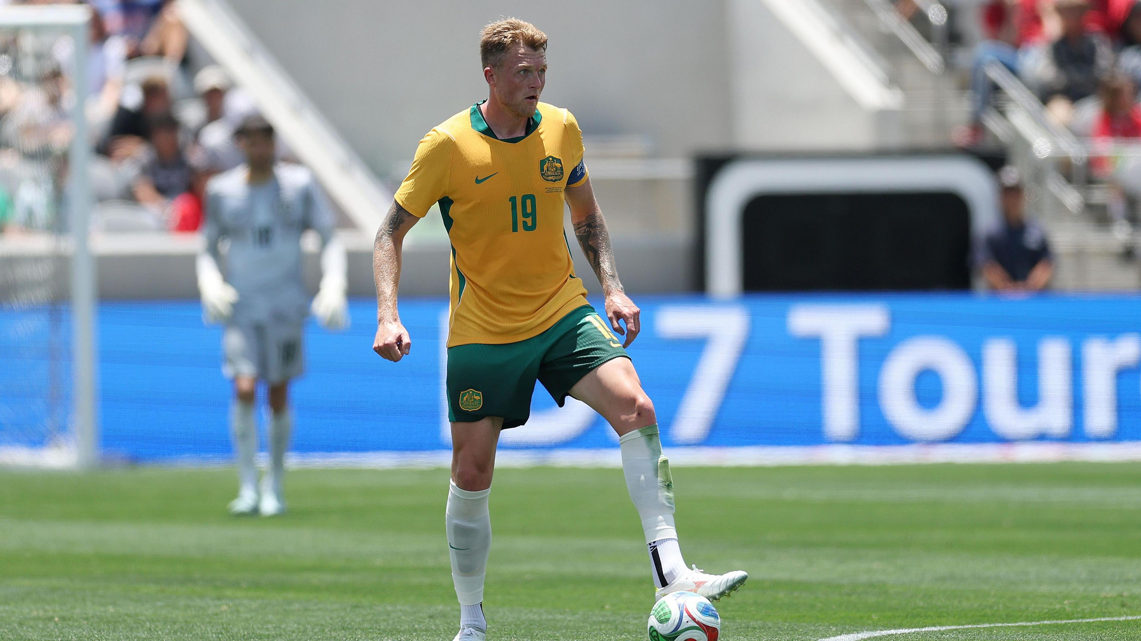 Harry Souttar, wearing Australia's yellow and green home kit, in action against Switzerland on 6 June