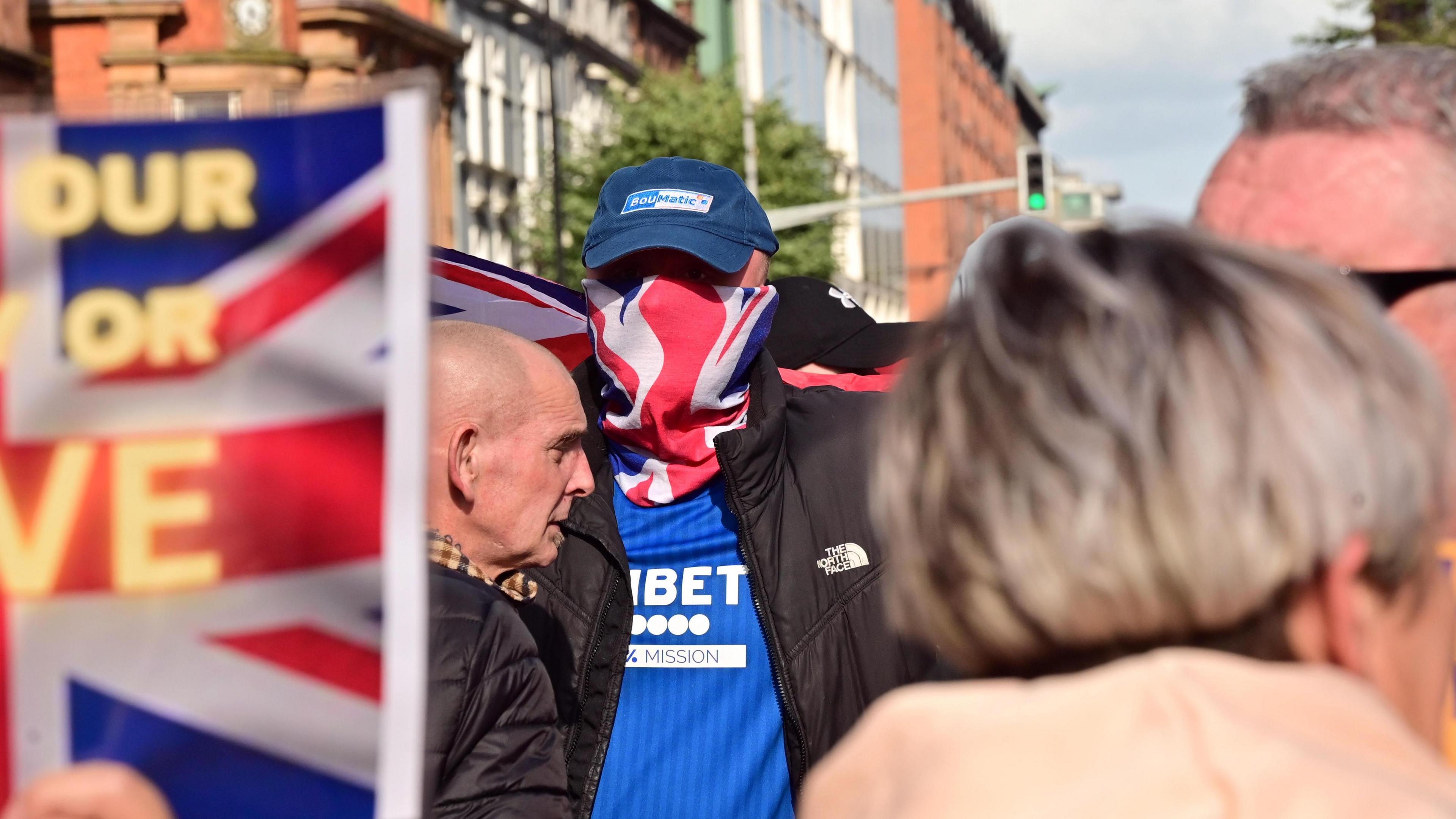 Protestors with posters and union jack around face