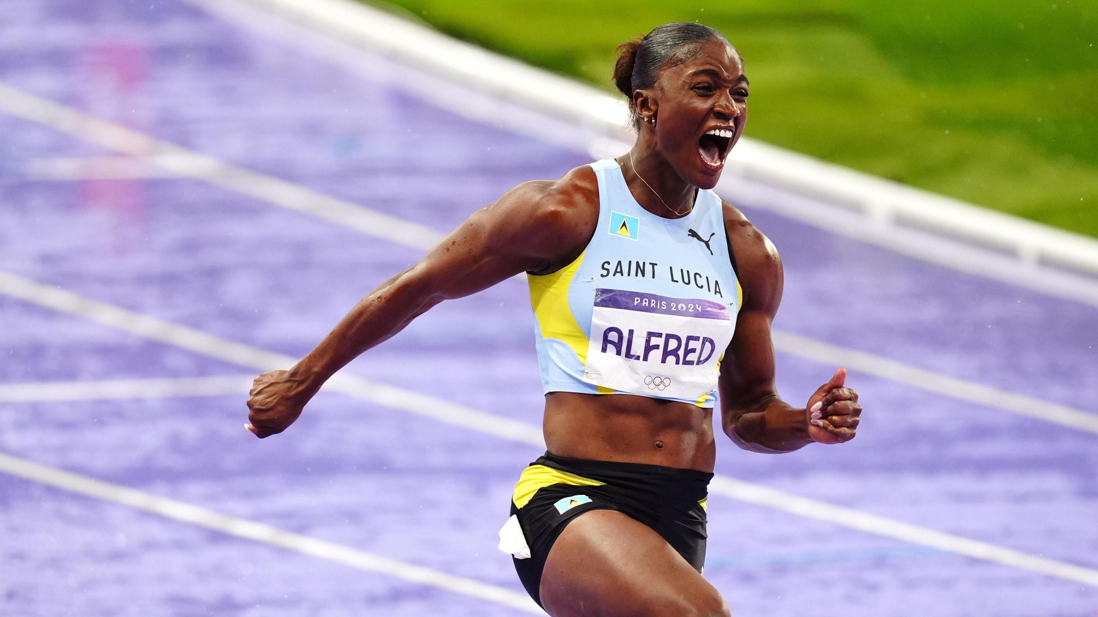 Saint Lucia's Julien Alfred celebrates winning the Women's 100m Final at the Stade de France on the eighth day of the 2024 Paris Olympic Games in France.