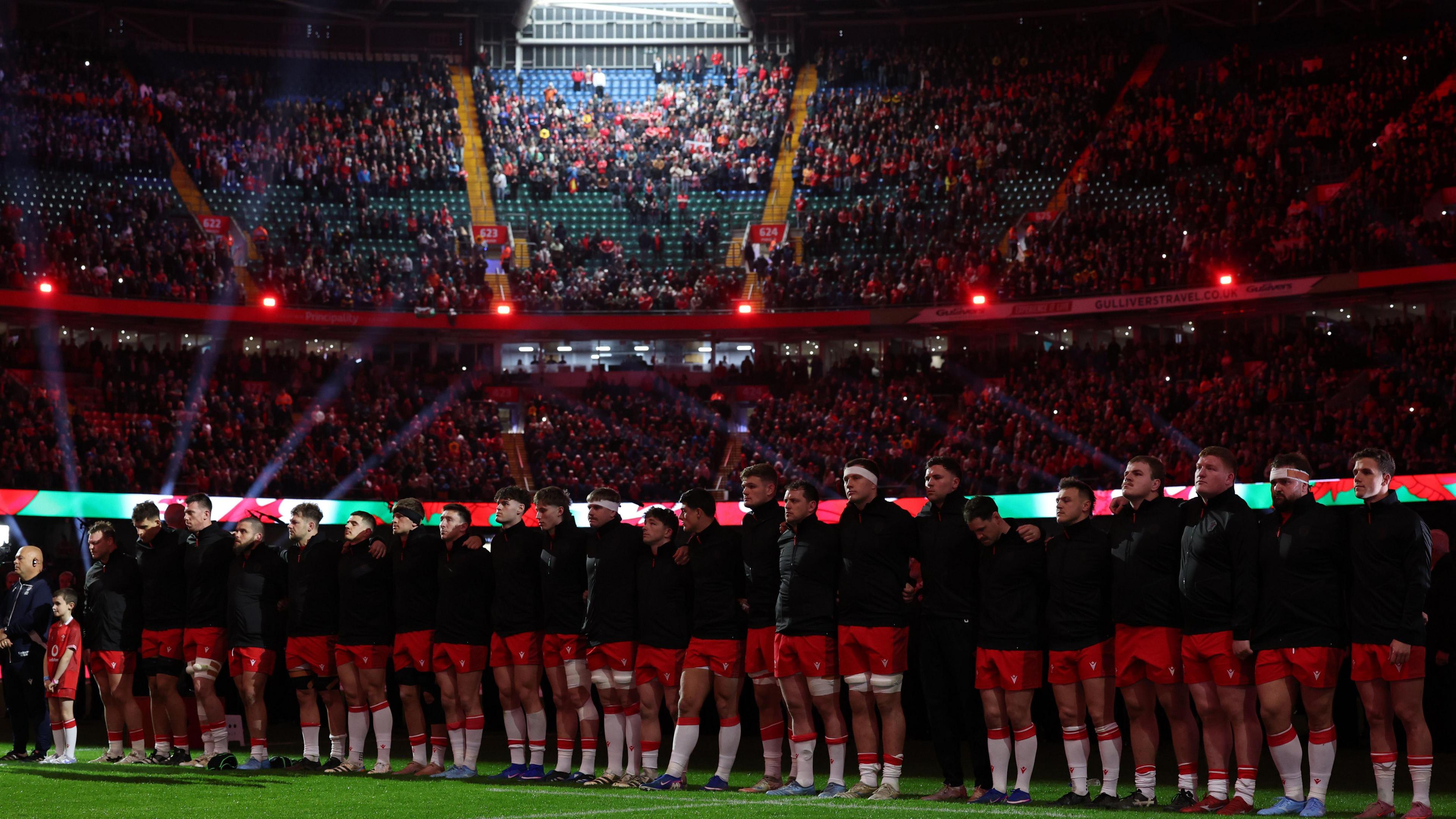 Wales line up for the national anthems at Principality Stadium before the game against France