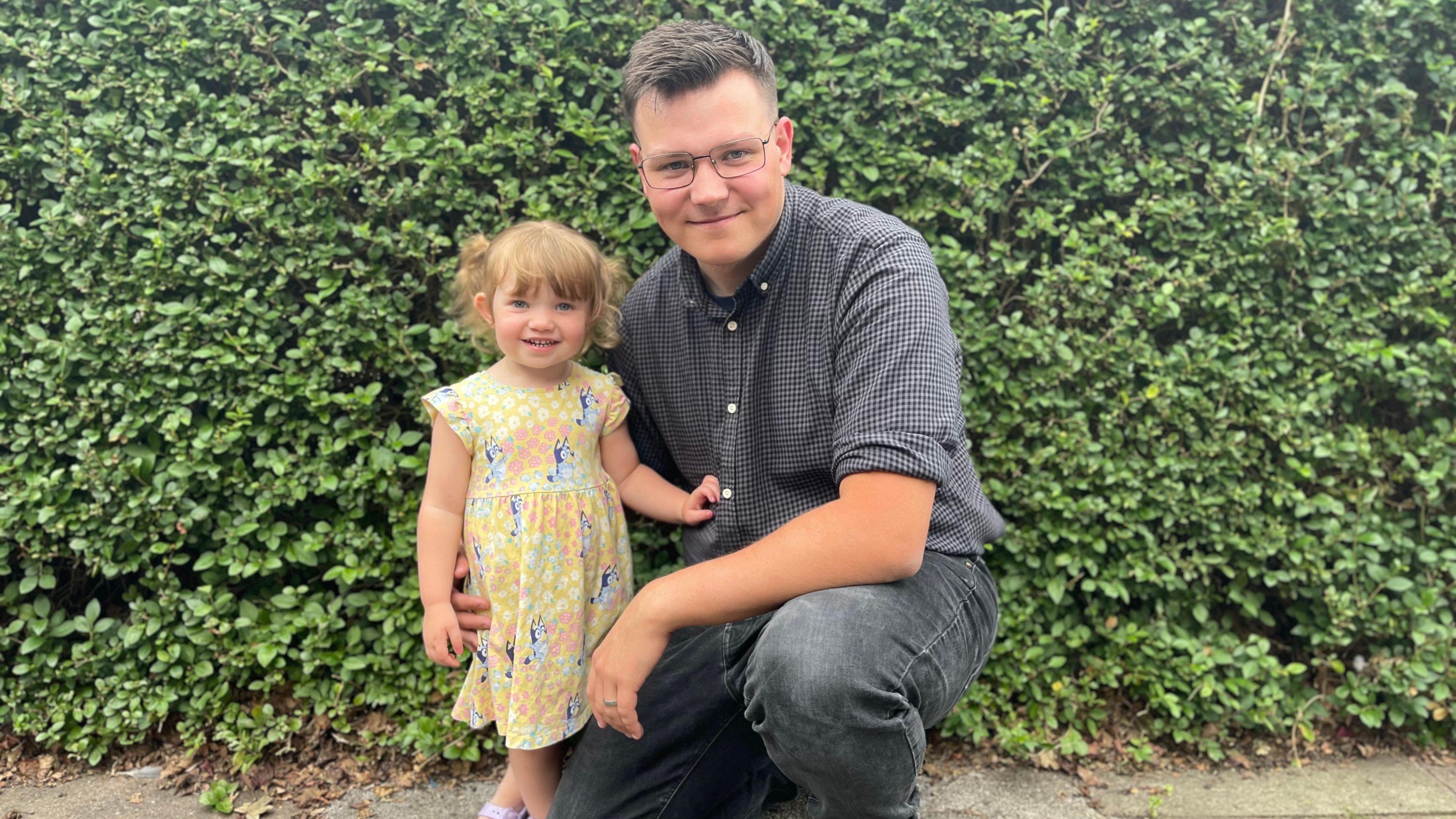 Connor pictured with his daughter, who is wearing a summer dress.