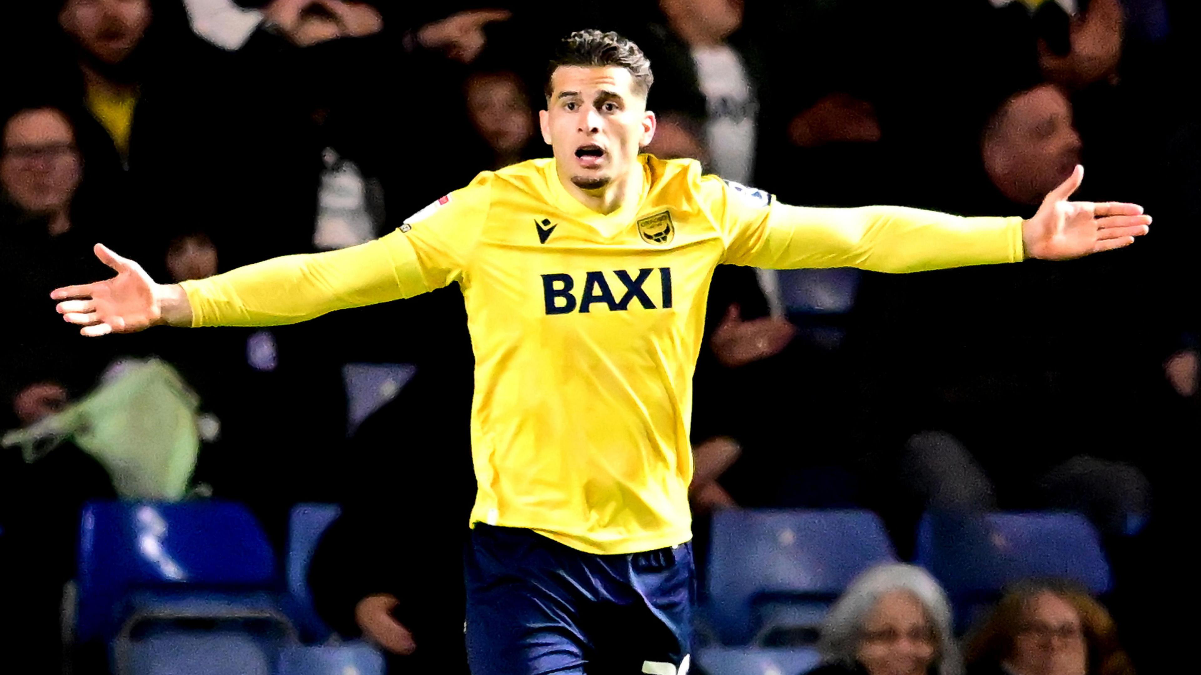 Ruben Rodrigues gestures with his arms out wide while playing for Oxford United