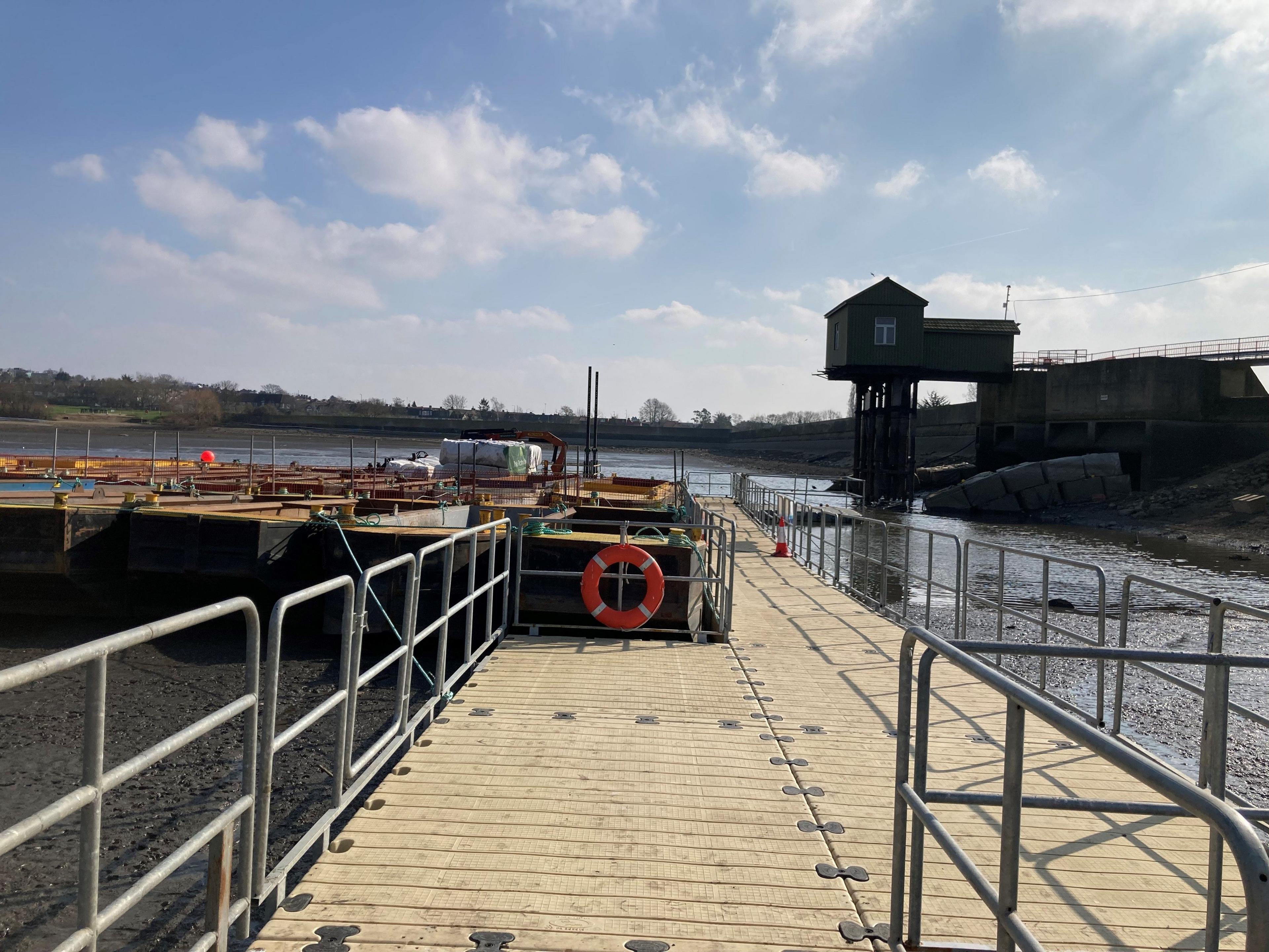 Image showing a walkway in front of a reservoir tower over the river