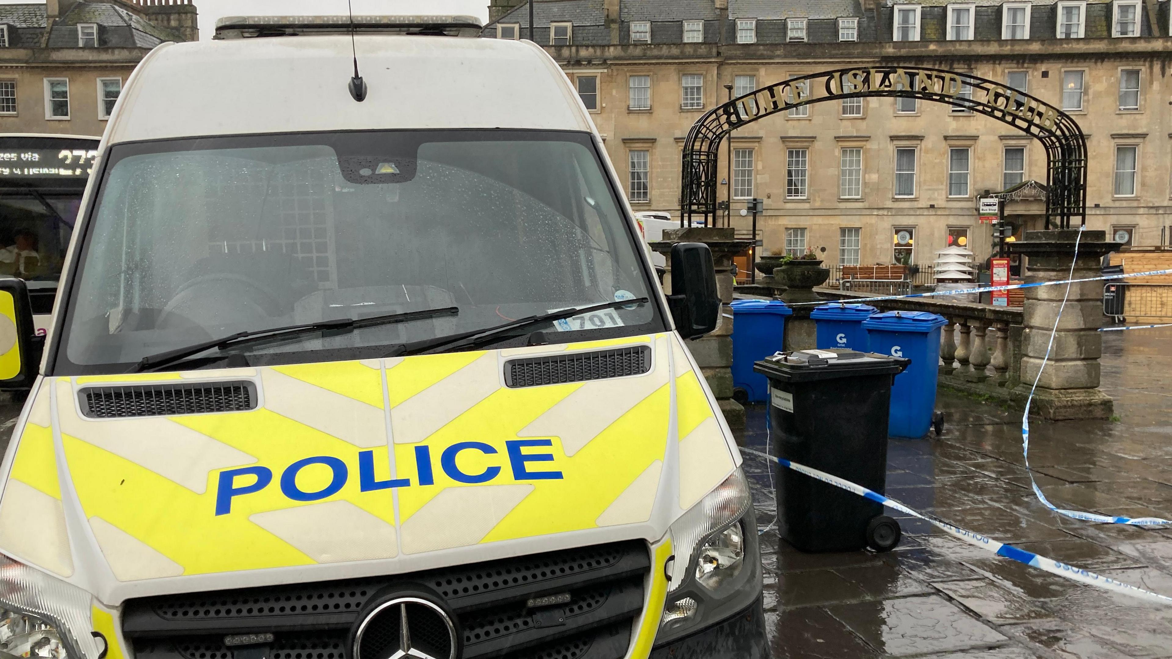 A police van parked on Terrace Walk in Bath. A cordon is to the right of the van over the pathway