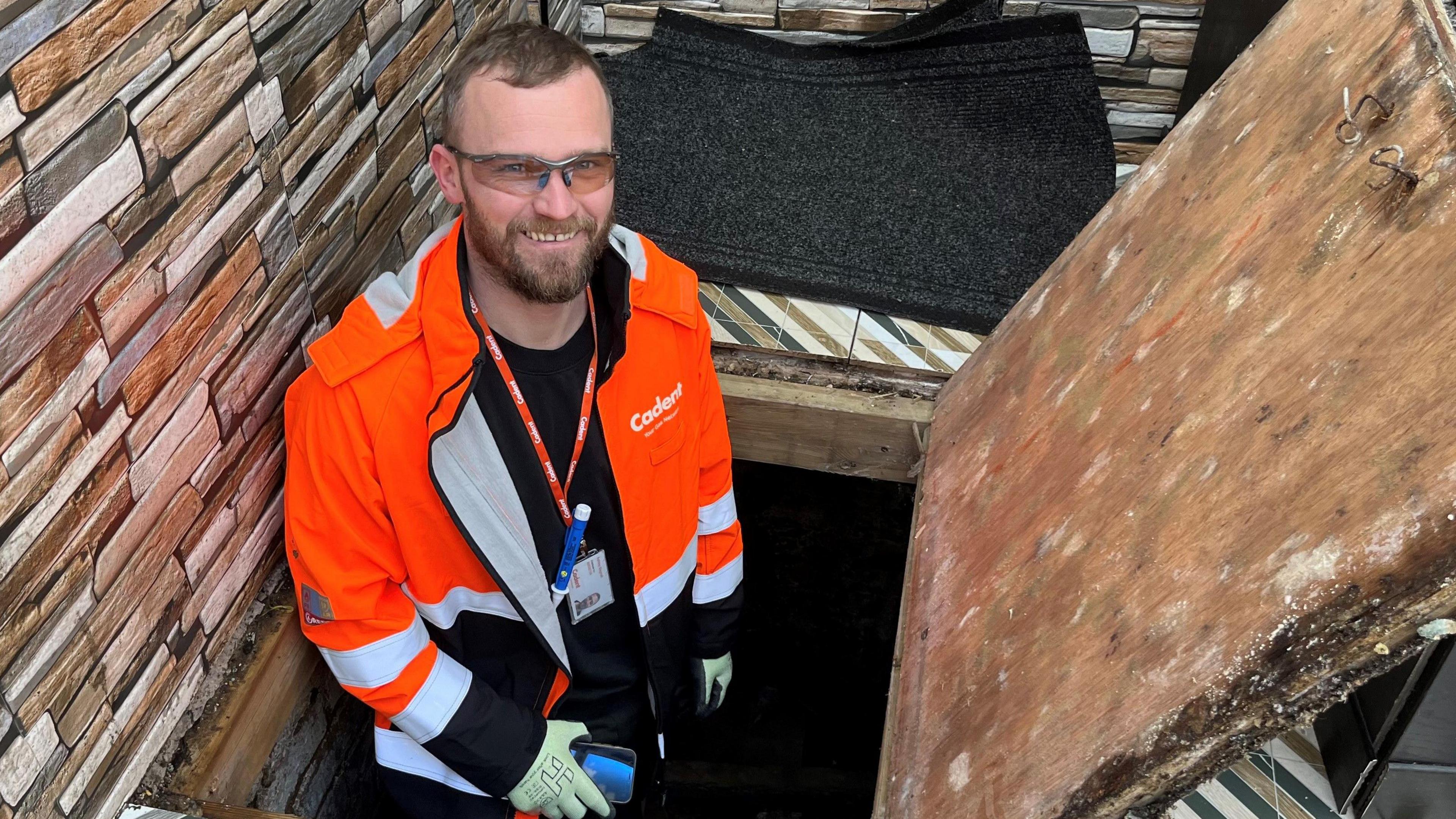 Gas inspector Ash Bagnall heading down into a cellar beneath a chicken shop to check the meter