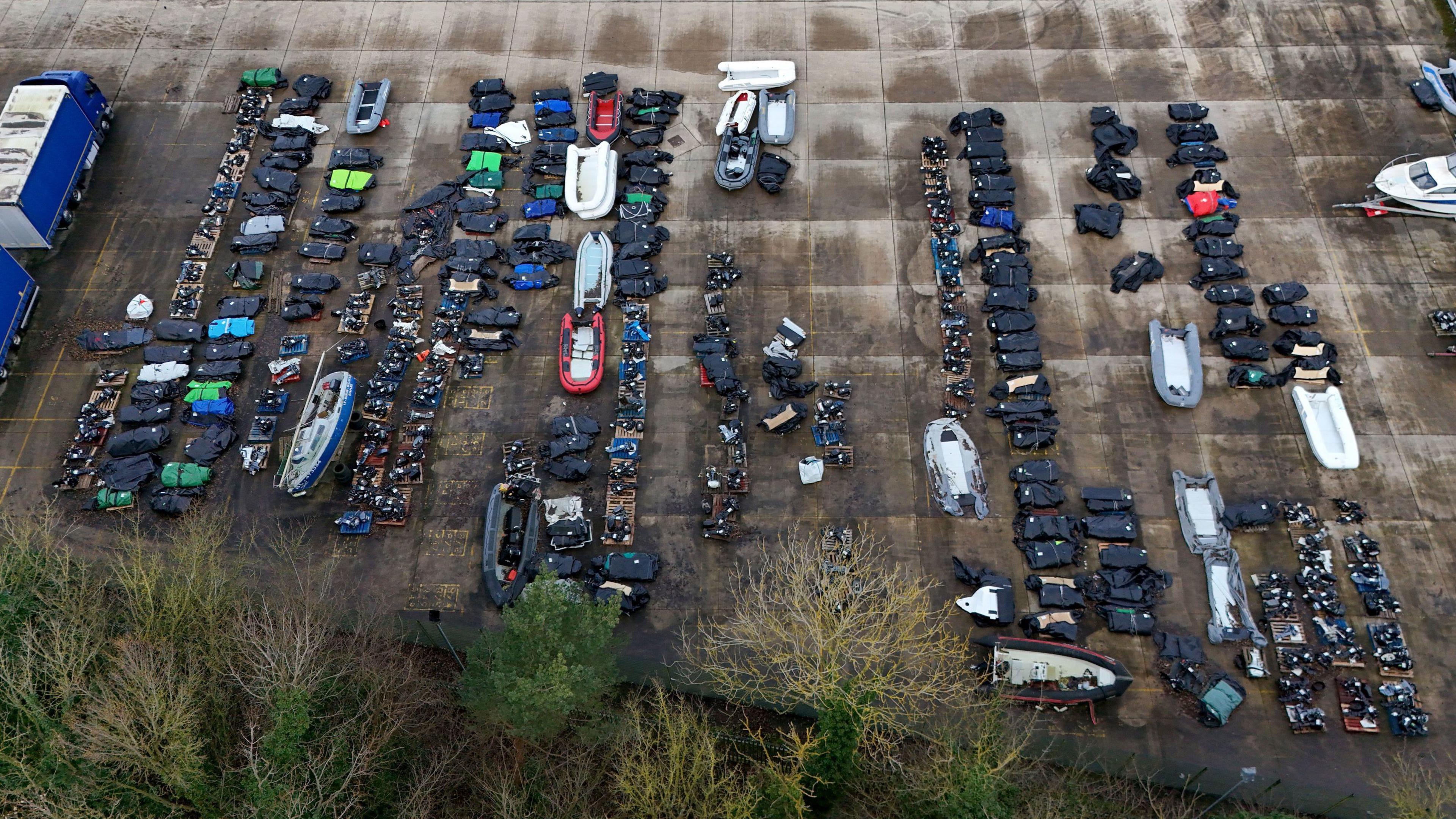 An aerial view of small boats and outboard motors used by people thought to be migrants to cross the Channel from France at a warehouse facility in Dover, Kent. 