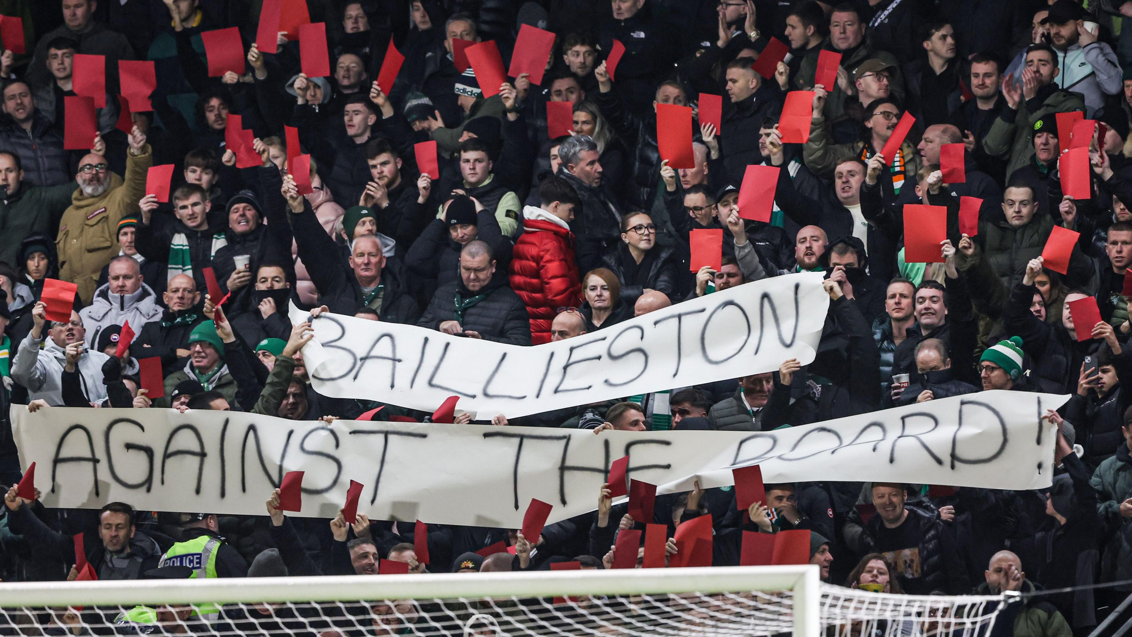 Celtic fans hold up red cards as part of their protest against the board