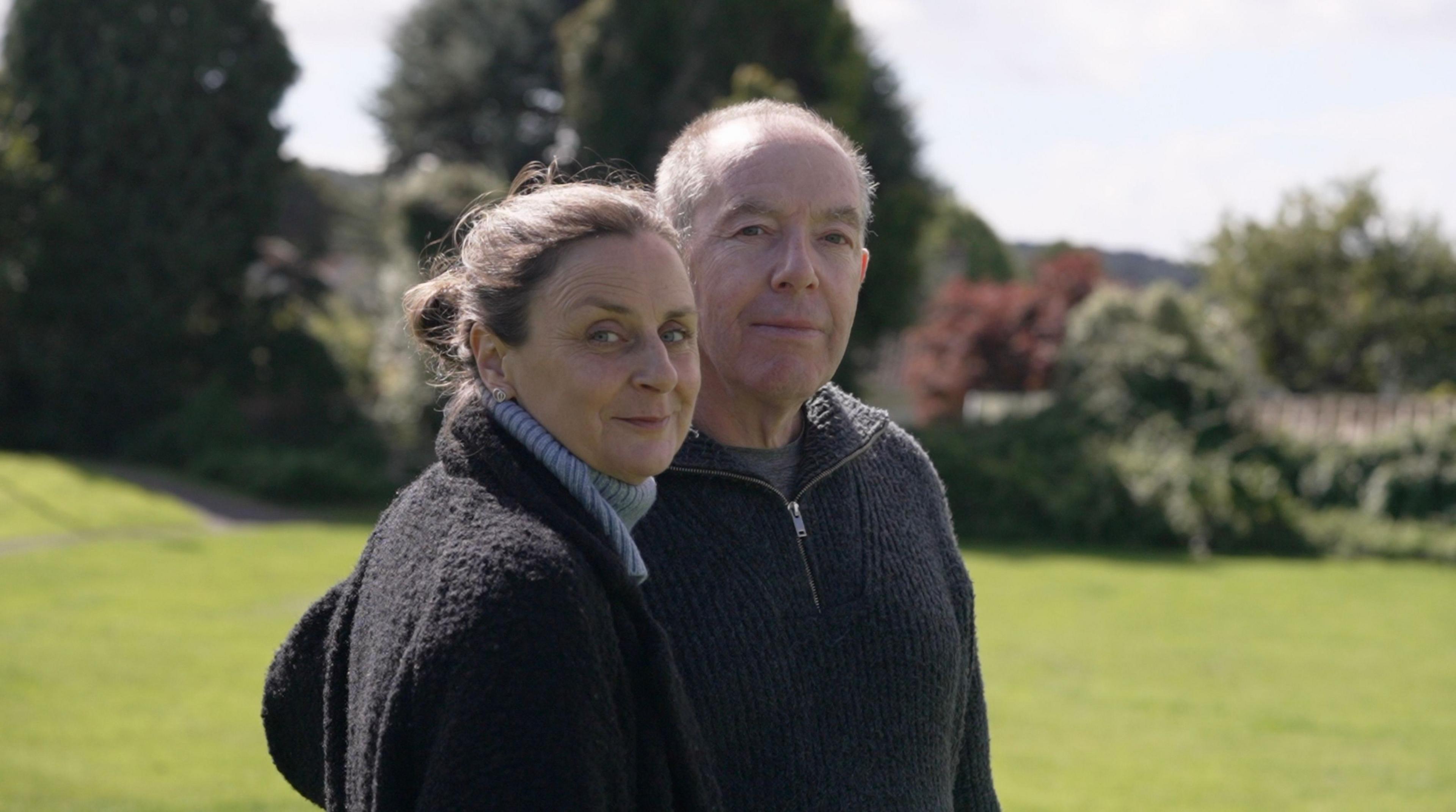 Portrait of Fergus' parents standing in the park where the sapling will be planted.