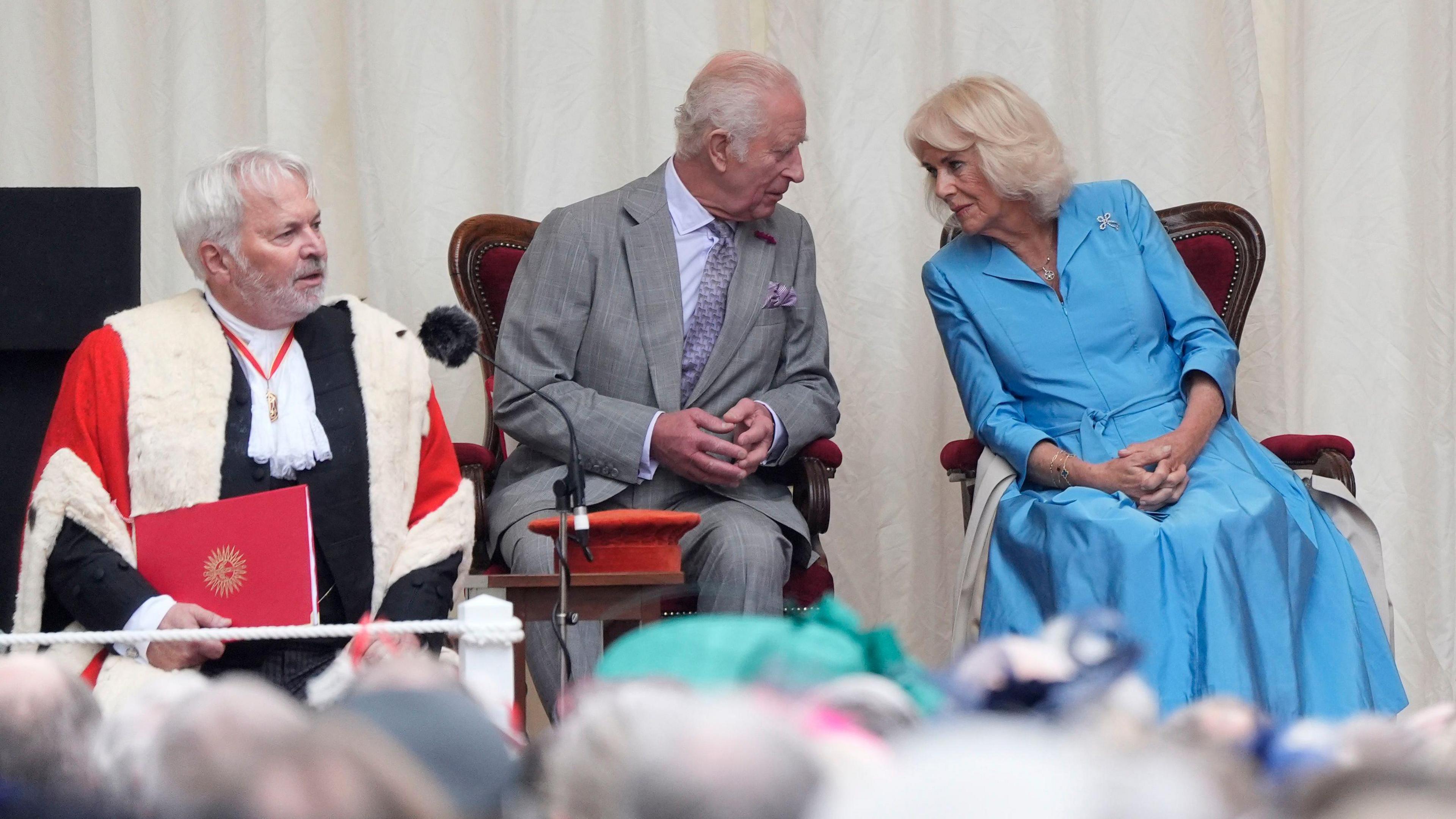 King Charles III and Queen Camilla at Royal Square in St Helier, Jersey, for a special sitting of the States Assembly and of the Royal Court, during their two day visit to the Channel Islands. The bailiff can be seen sitting to the left of the royals, slightly in front of them.