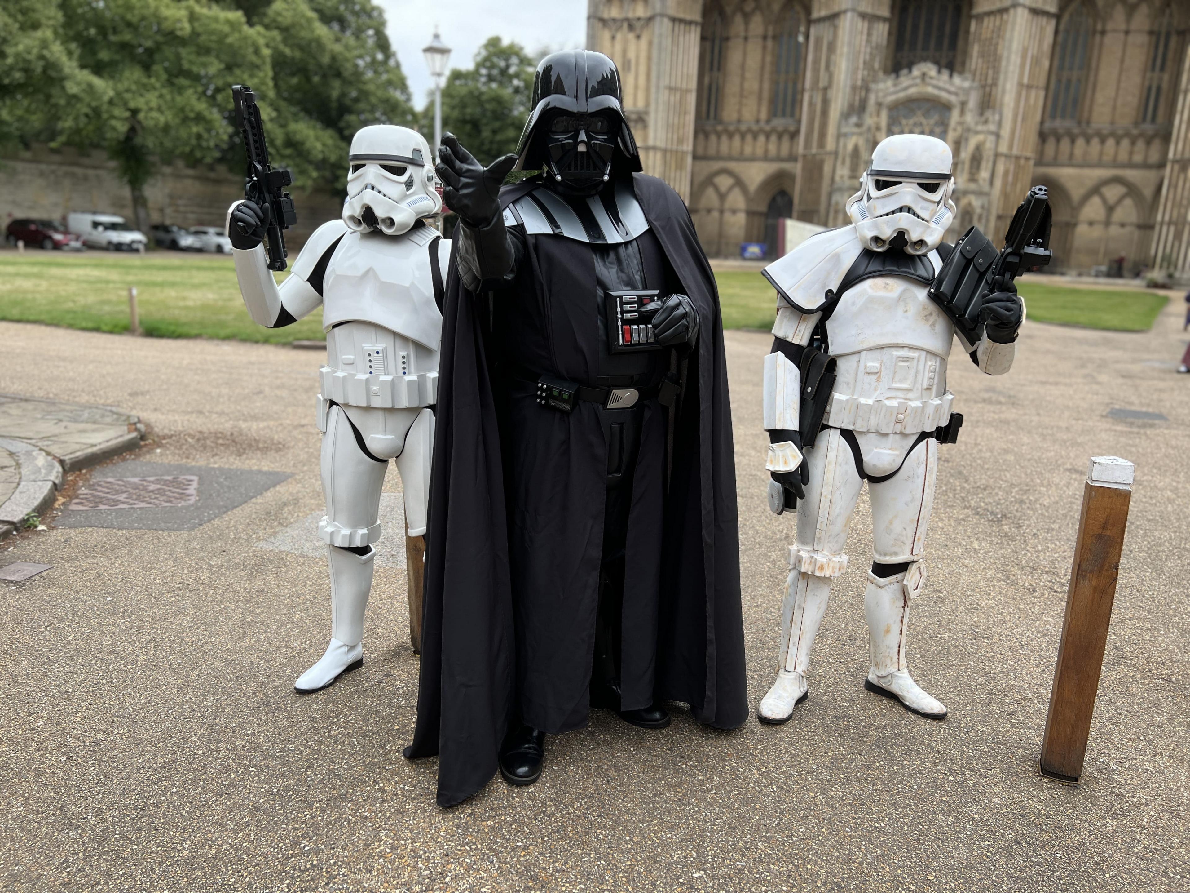 Darth Vader flanked by two Stormtroopers