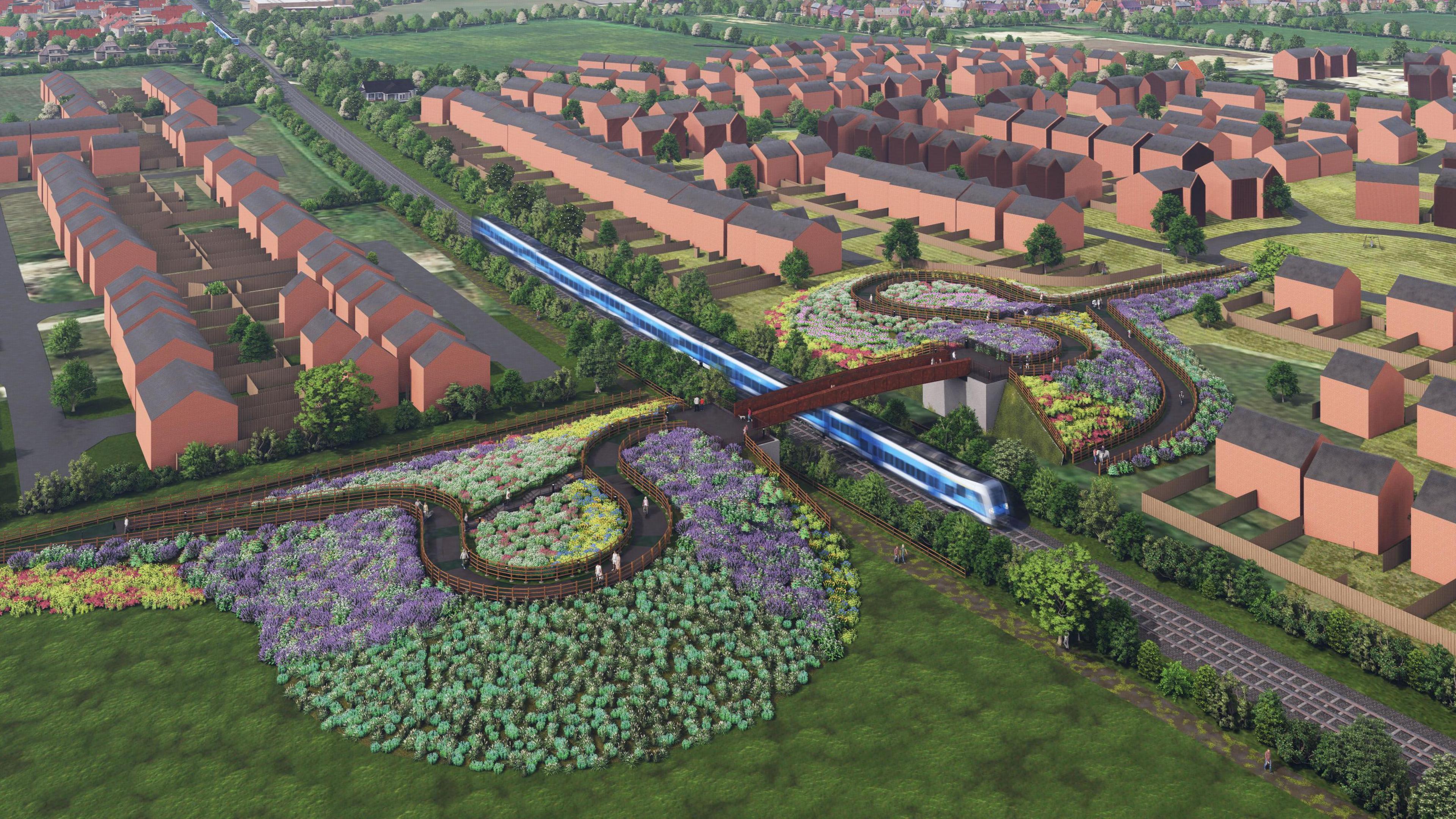 Bright, colourful flowers line a footpath leading up to a new railway bridge. 