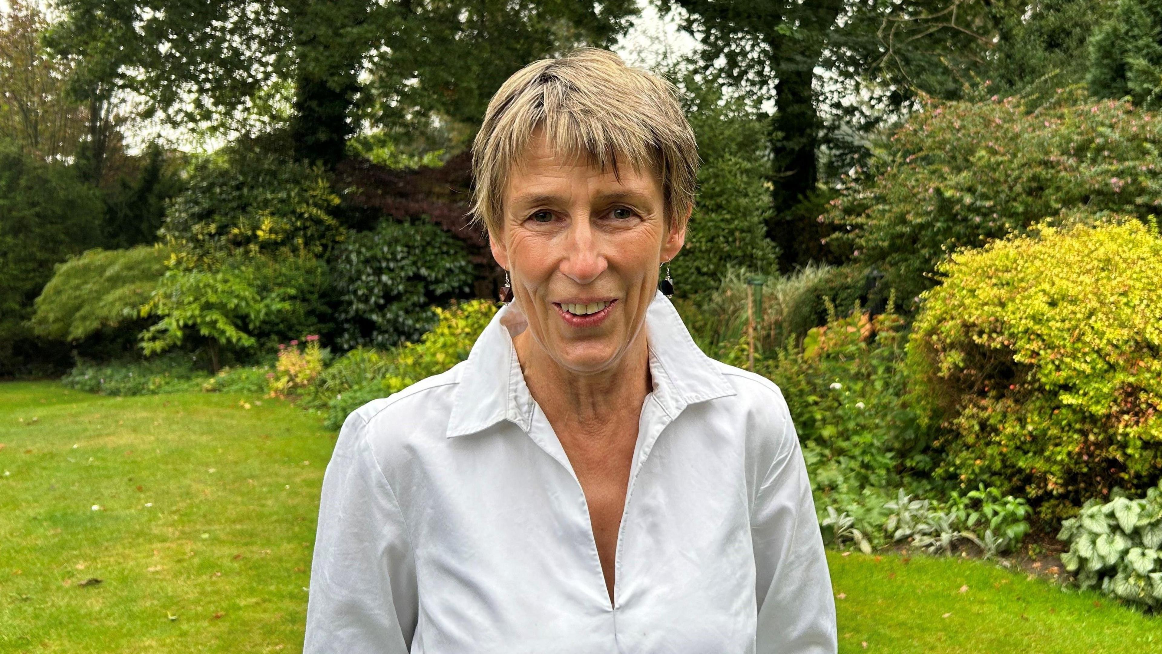 Arturo Fanconi's great-niece Gill Haggarty standing in a garden