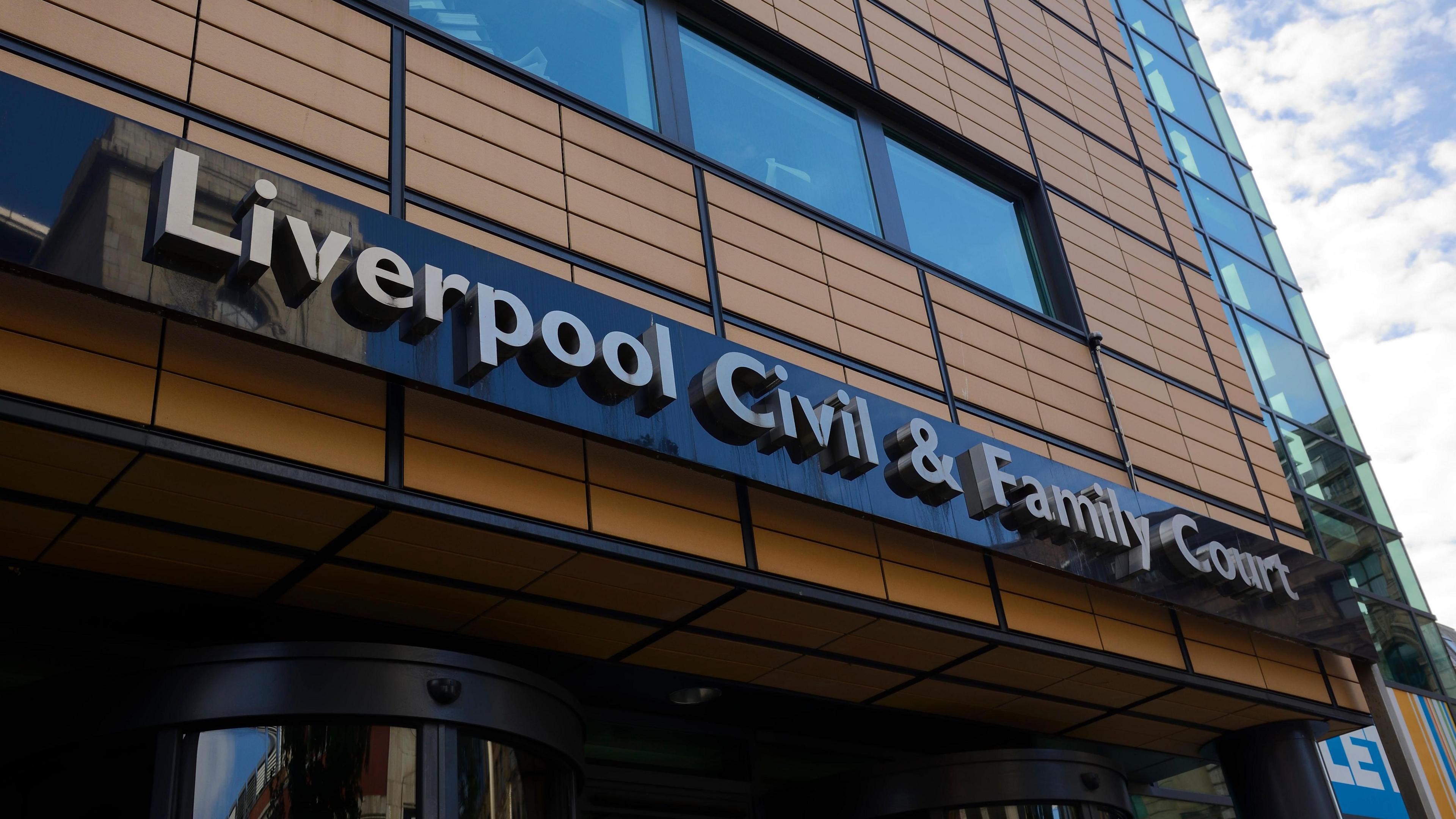 A tall brown building with the lettering "Liverpool Civil & Family Court"