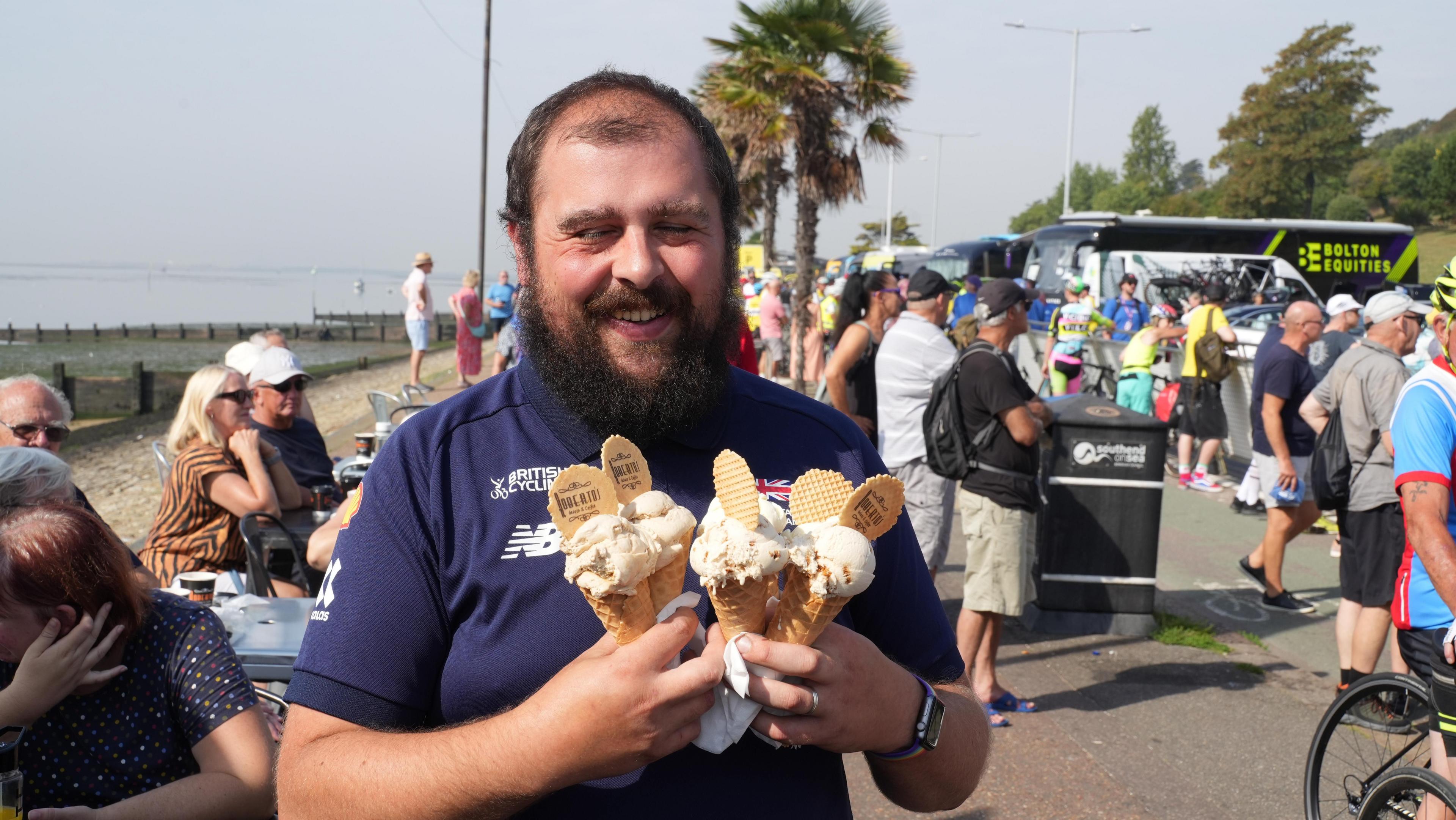 A man holding four icecreams