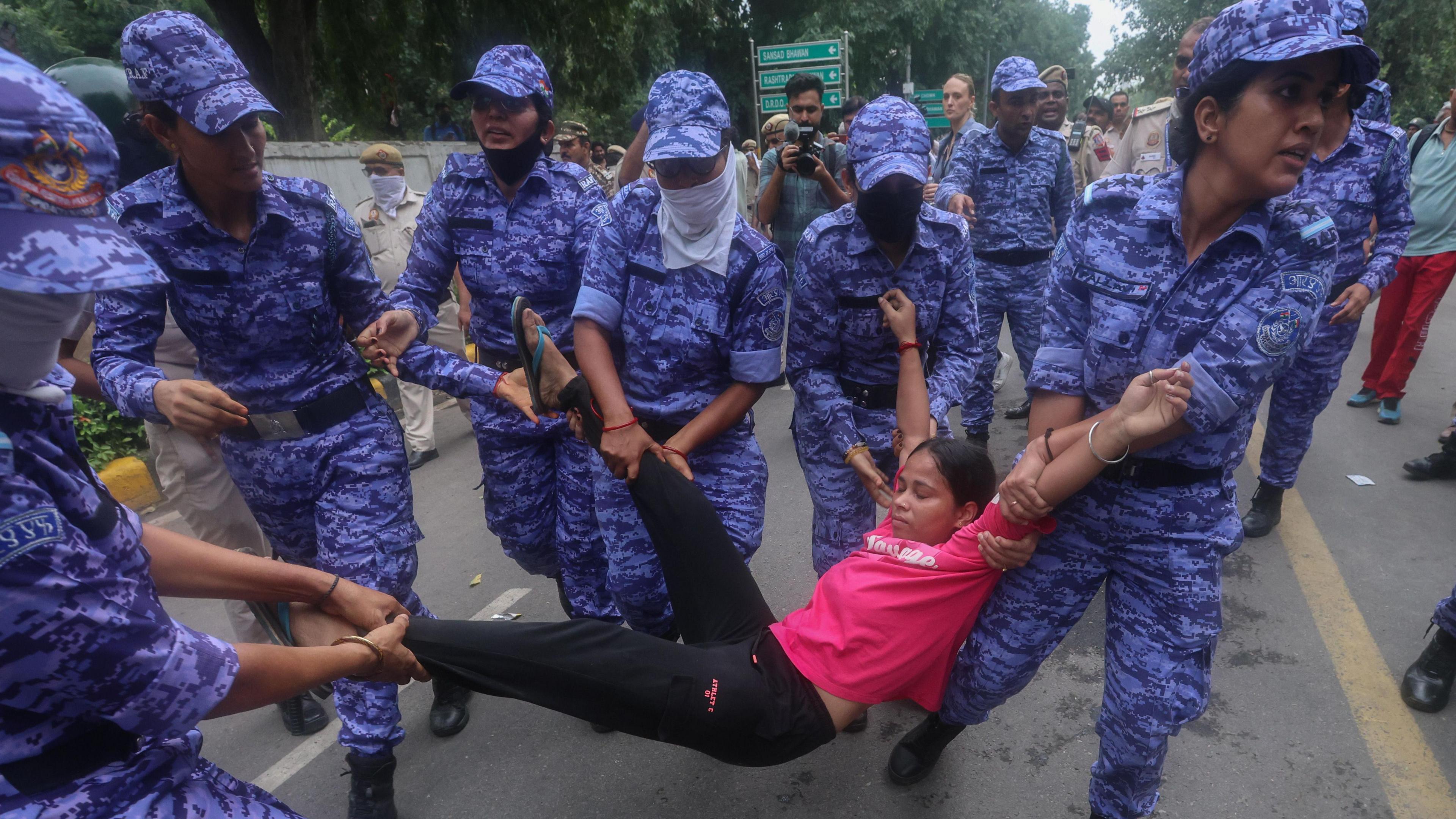 Indian security personnel detain protesters as they attempt to stop Cockroach Janta Party's(CJP) supporters during a march toward the Parliament in New Delhi, India, 20 July 2026. 