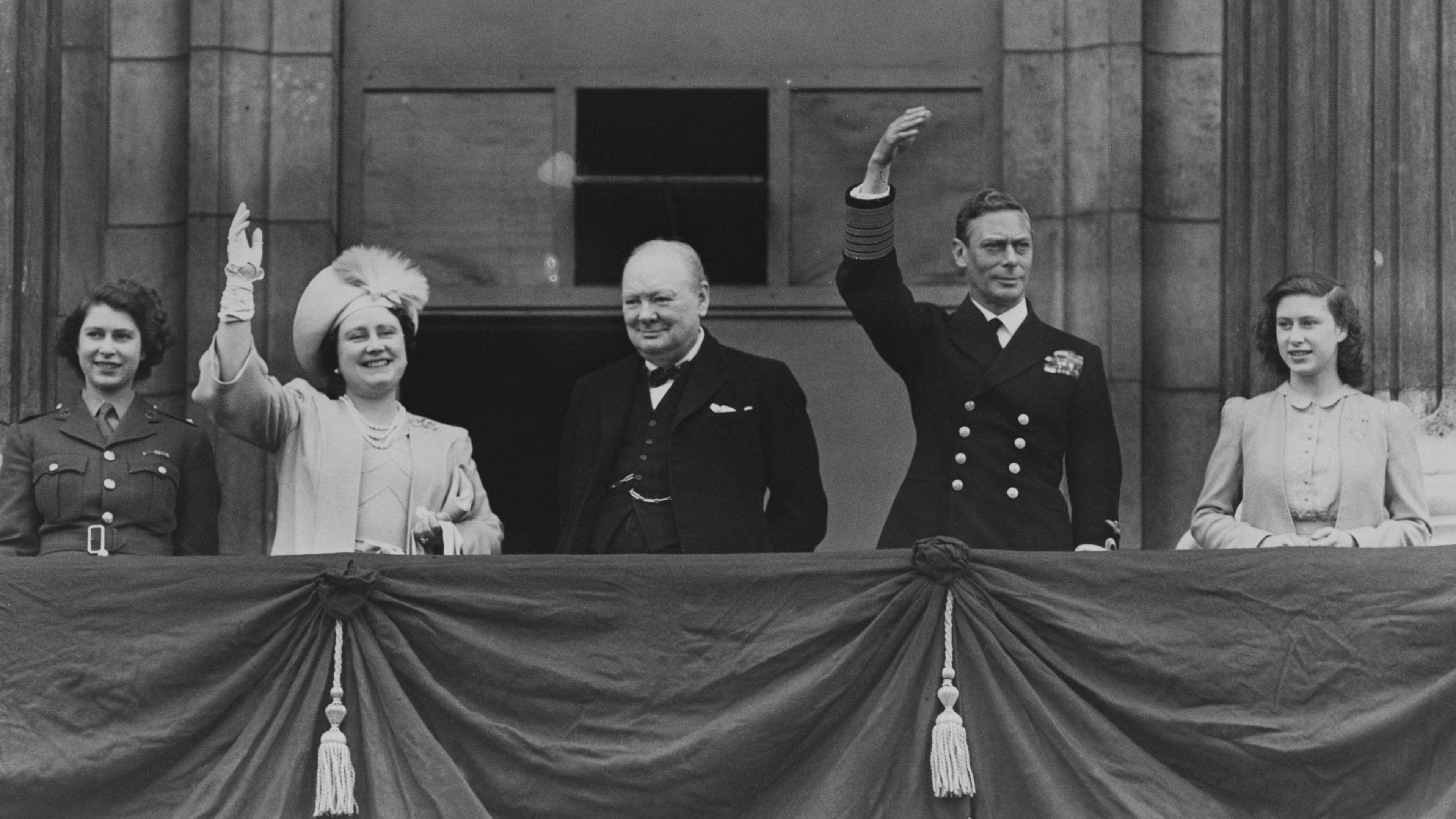 A view of the Buckingham Palace balcony on VE Day. From left to right, Queen Elizabeth II, the Queen Mother, Prime Minister Winston Churchill, King George VI and Princess Margaret.