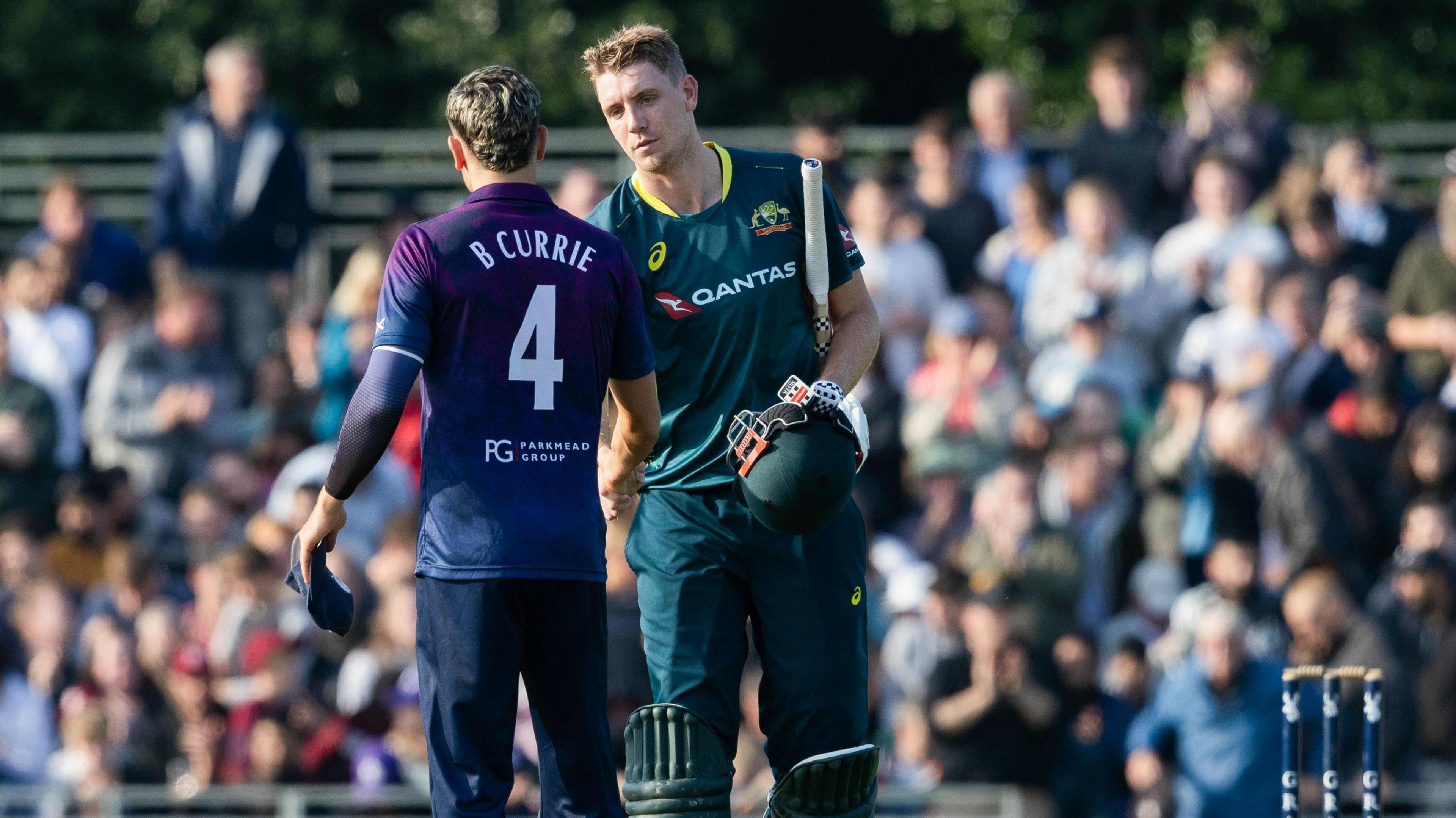 Cameron Green shakes Brad Currie's hand after Australia seal victory