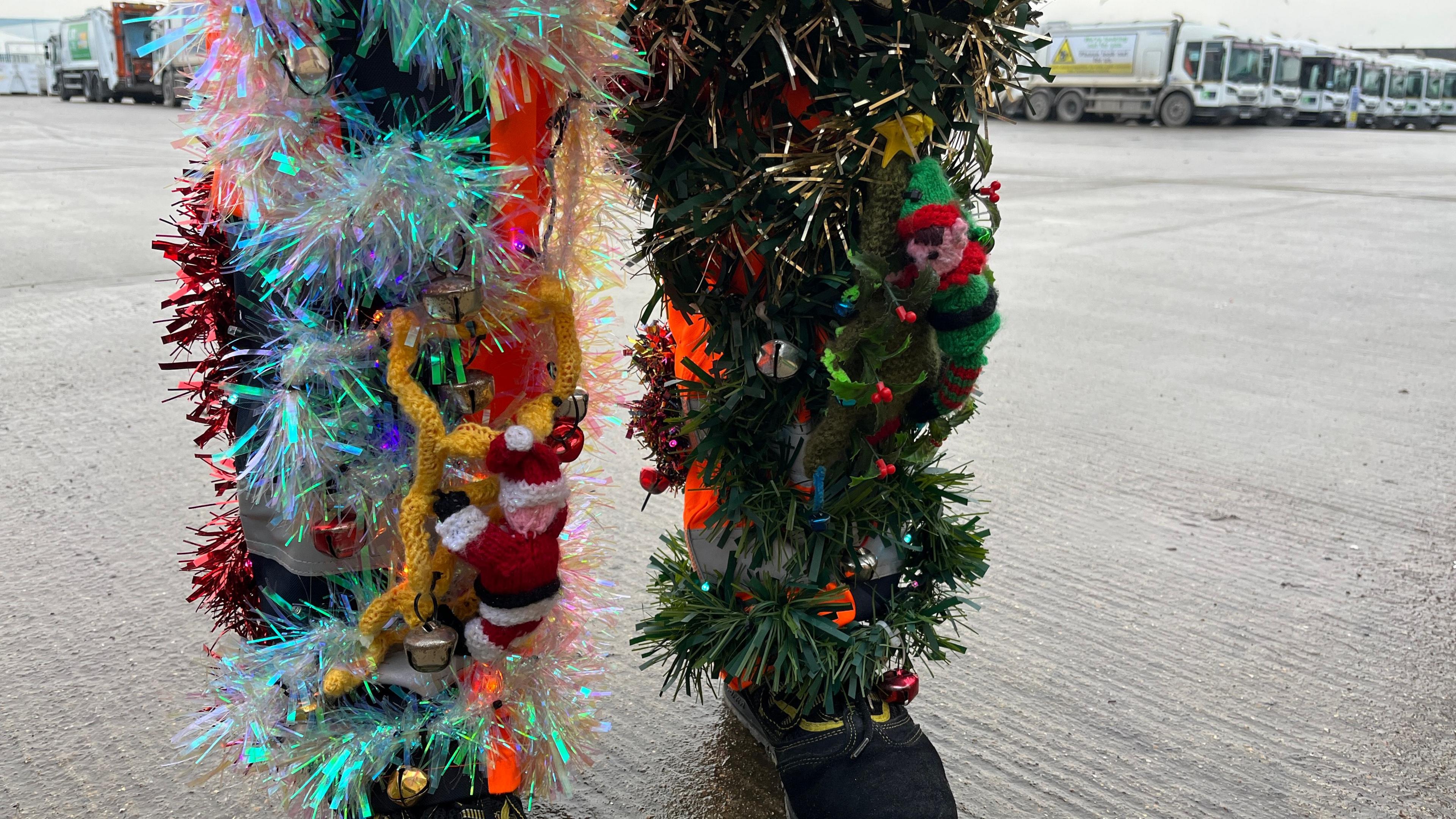 Lenny Edward legs are covered in tinsel. There are knitted elves attached to the tinsel on his uniform which look as though they are climbing up his legs. 