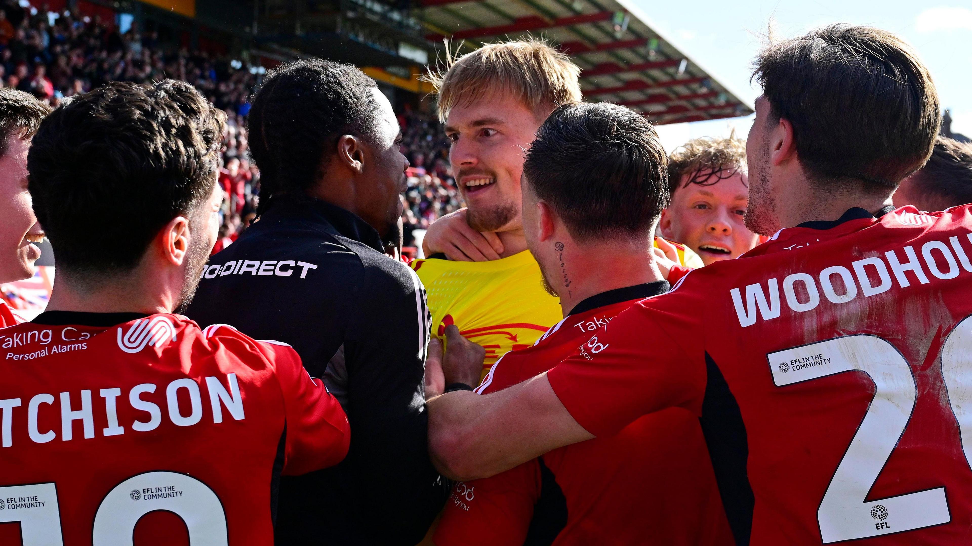 Jack Bycroft is mobbed by his teammates after scoring for Exeter City