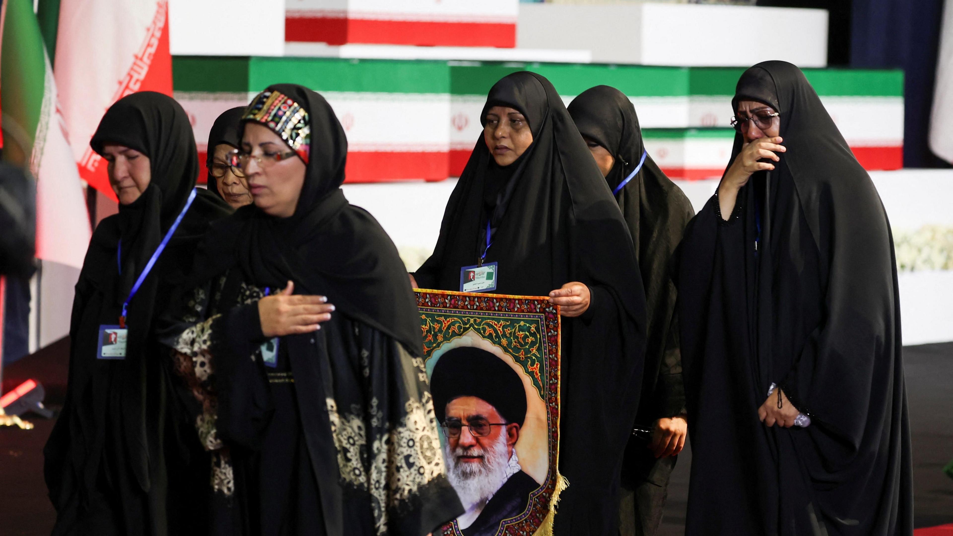Women react near the coffins of Iran's late Supreme Leader Ayatollah Ali Khamenei and his family members.