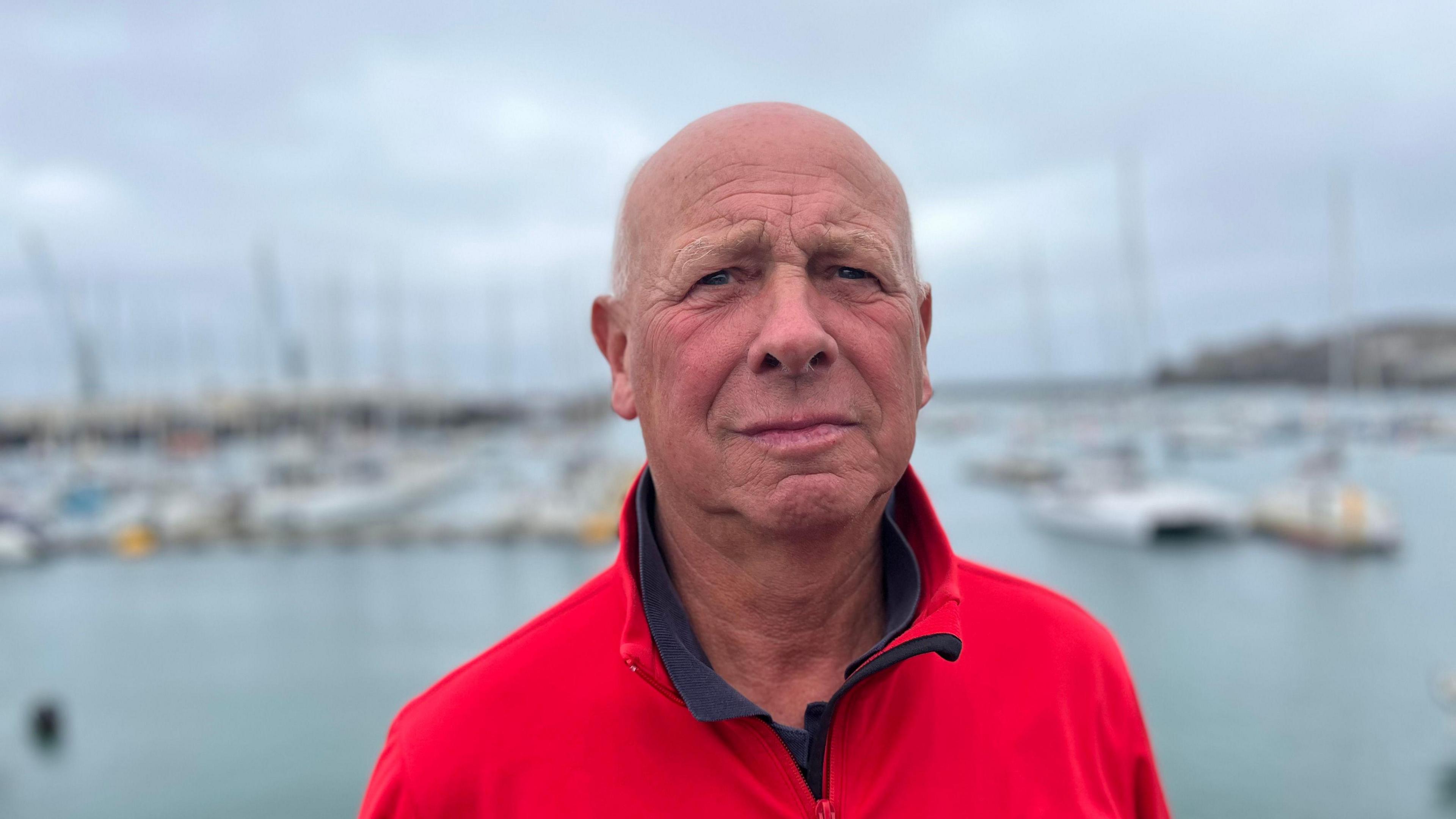 Nigel Vooght wearing a red fleece, looking at the camera