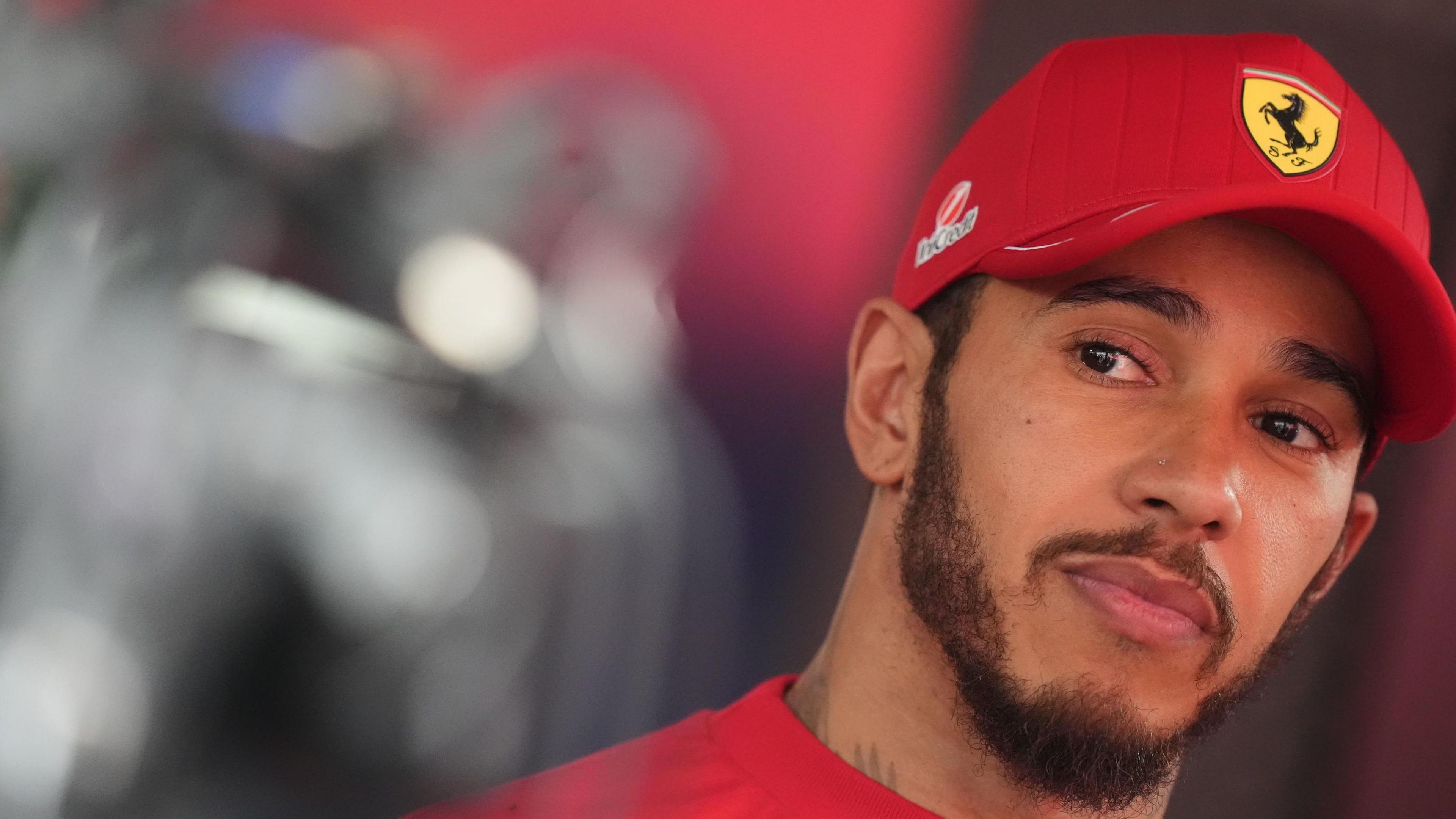Lewis Hamilton pictured at the Belgian Grand Prix wearing a Ferrari cap