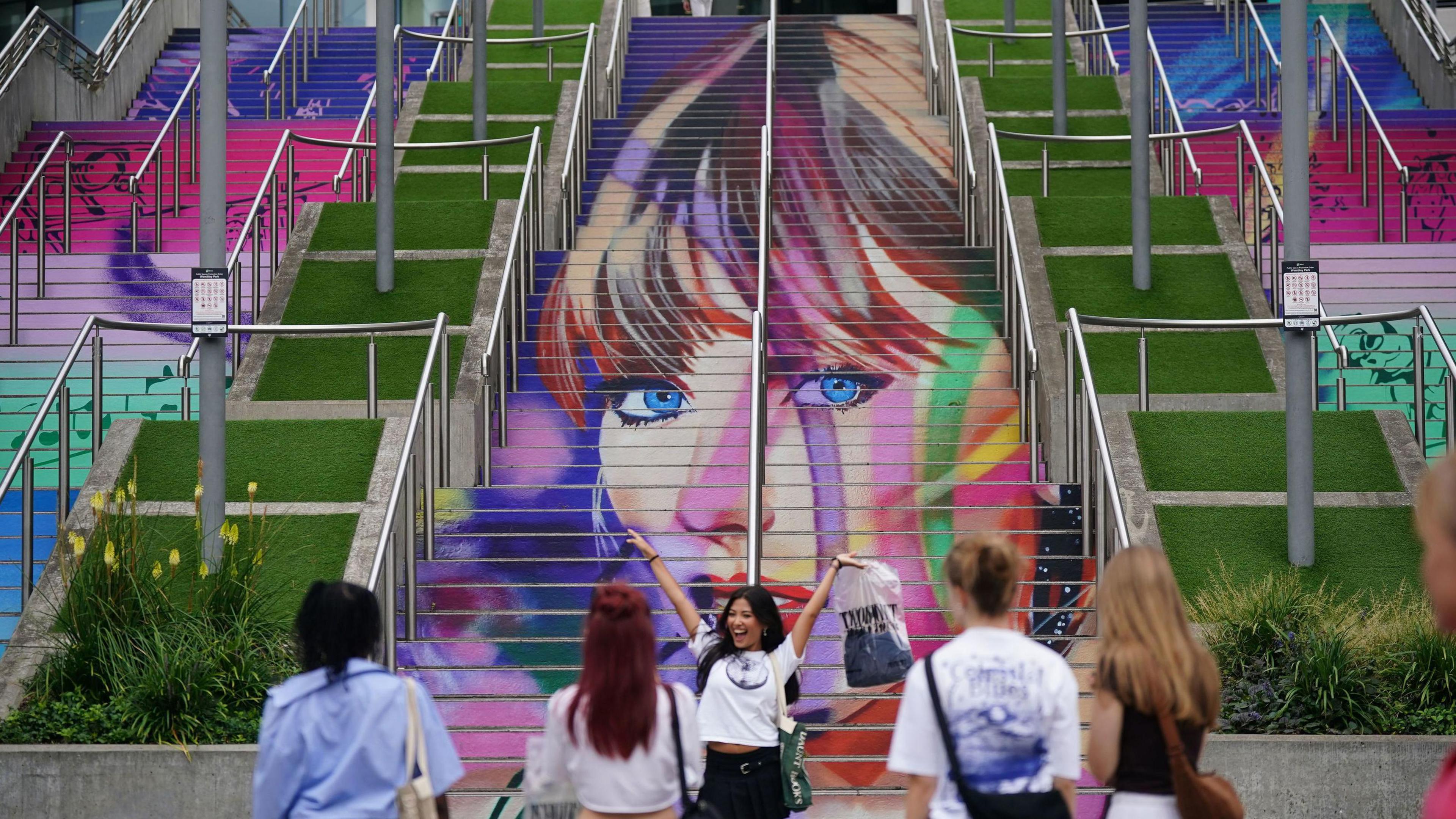 A set of steps outside the Wembley Stadium painted in a mural of Taylor Swift 