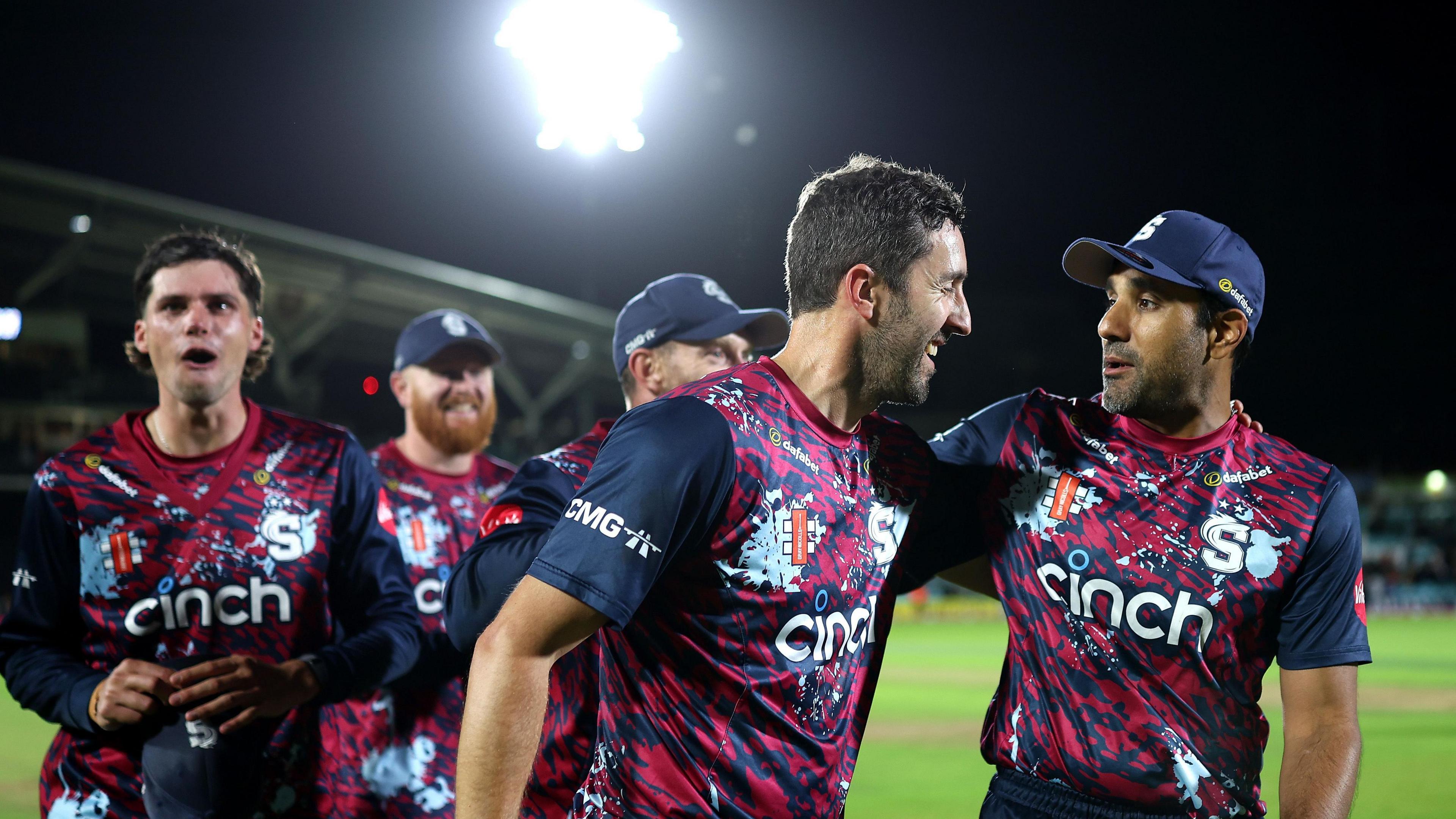 Ben Sanderson (centre) has his left arm around the shoulder of Ravi Bopara as they leave the field at The Kia Oval with three players following behind them