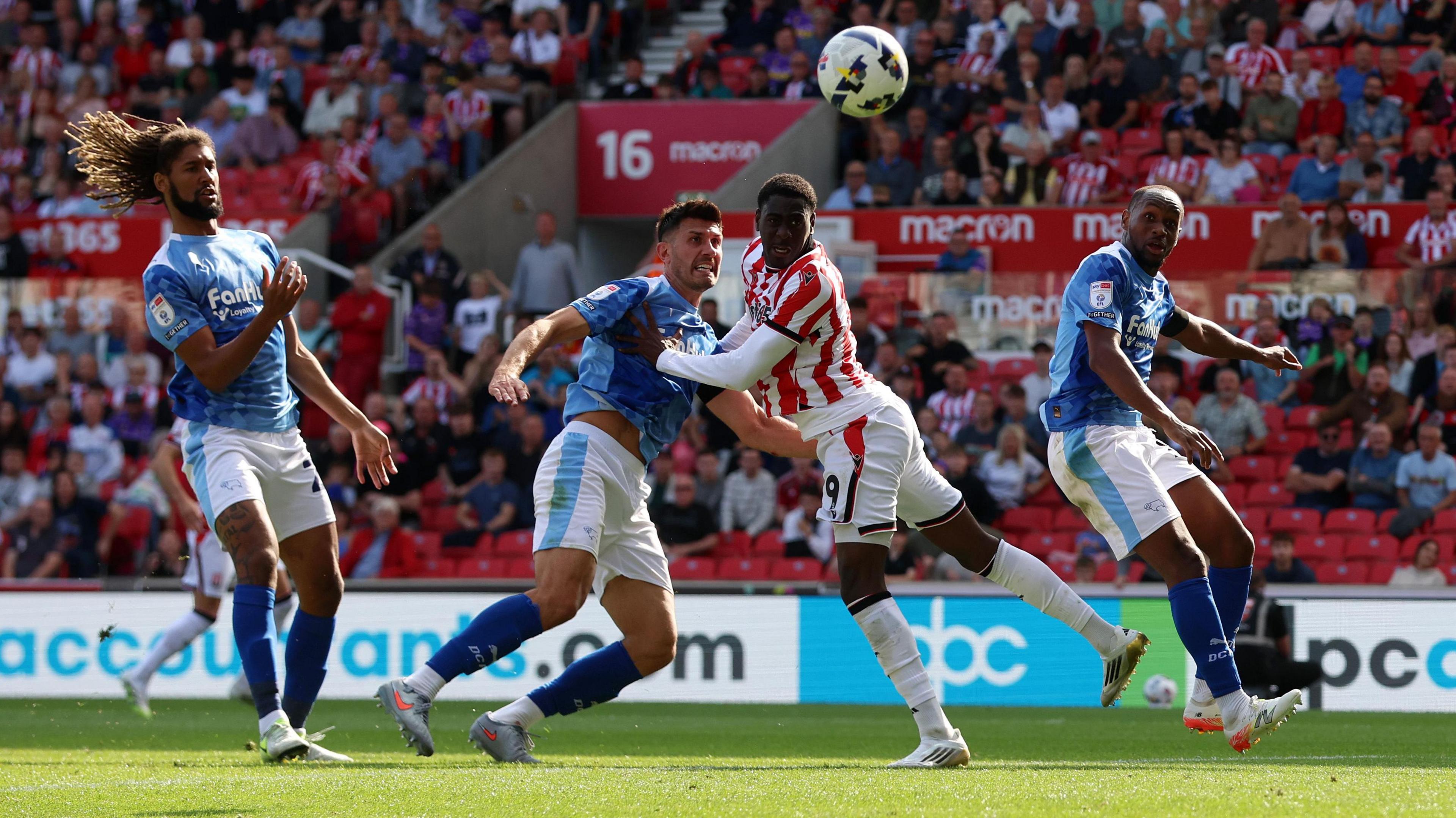 Stoke Divin Mubama (second right) watches as the ball goes towards the goal