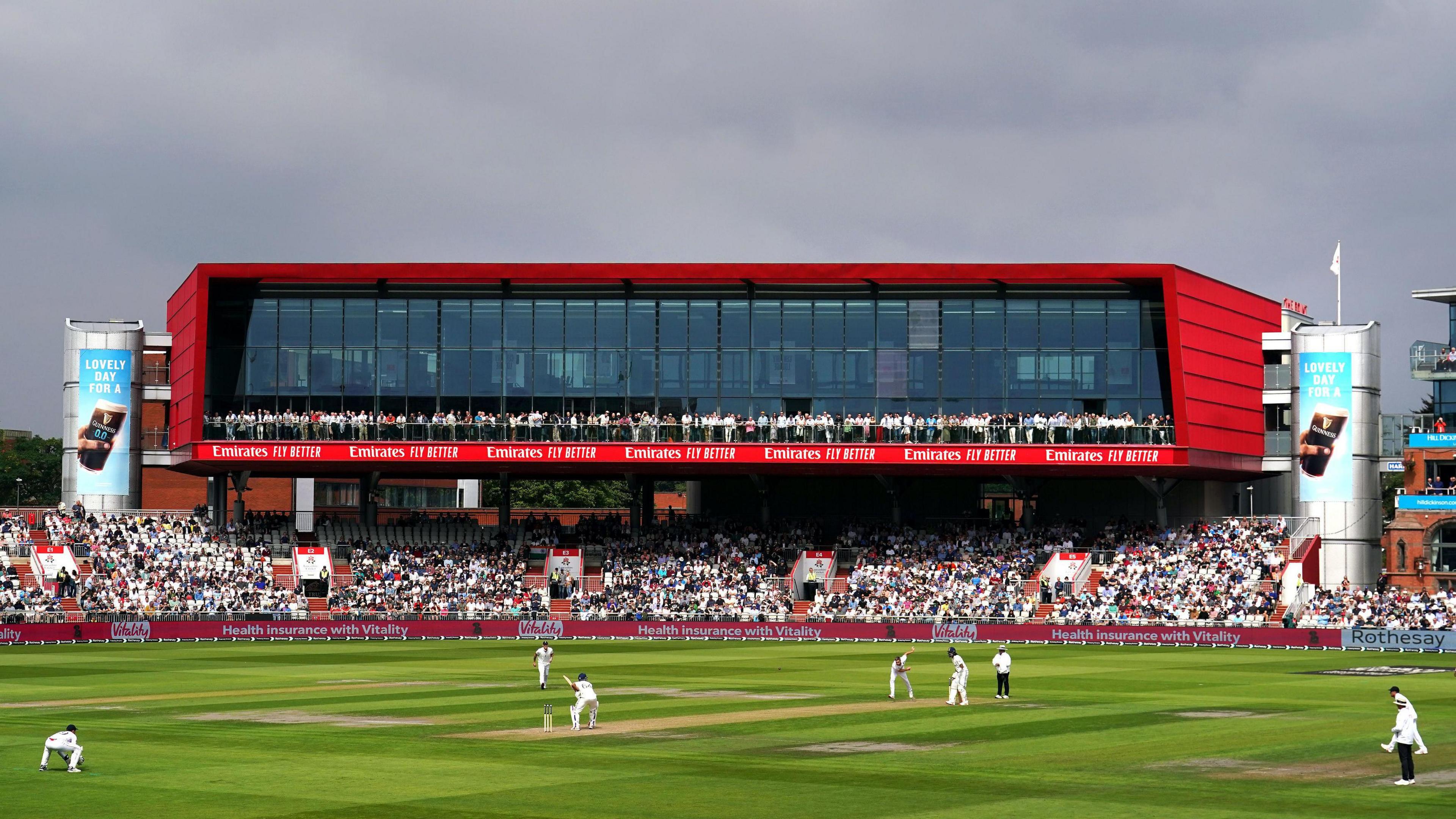 The Emirates Old Trafford stand as England's Chris Woakes bowls to India's Yashasvi Jaiswal on day one of the Fourth Rothesay Men's Test.