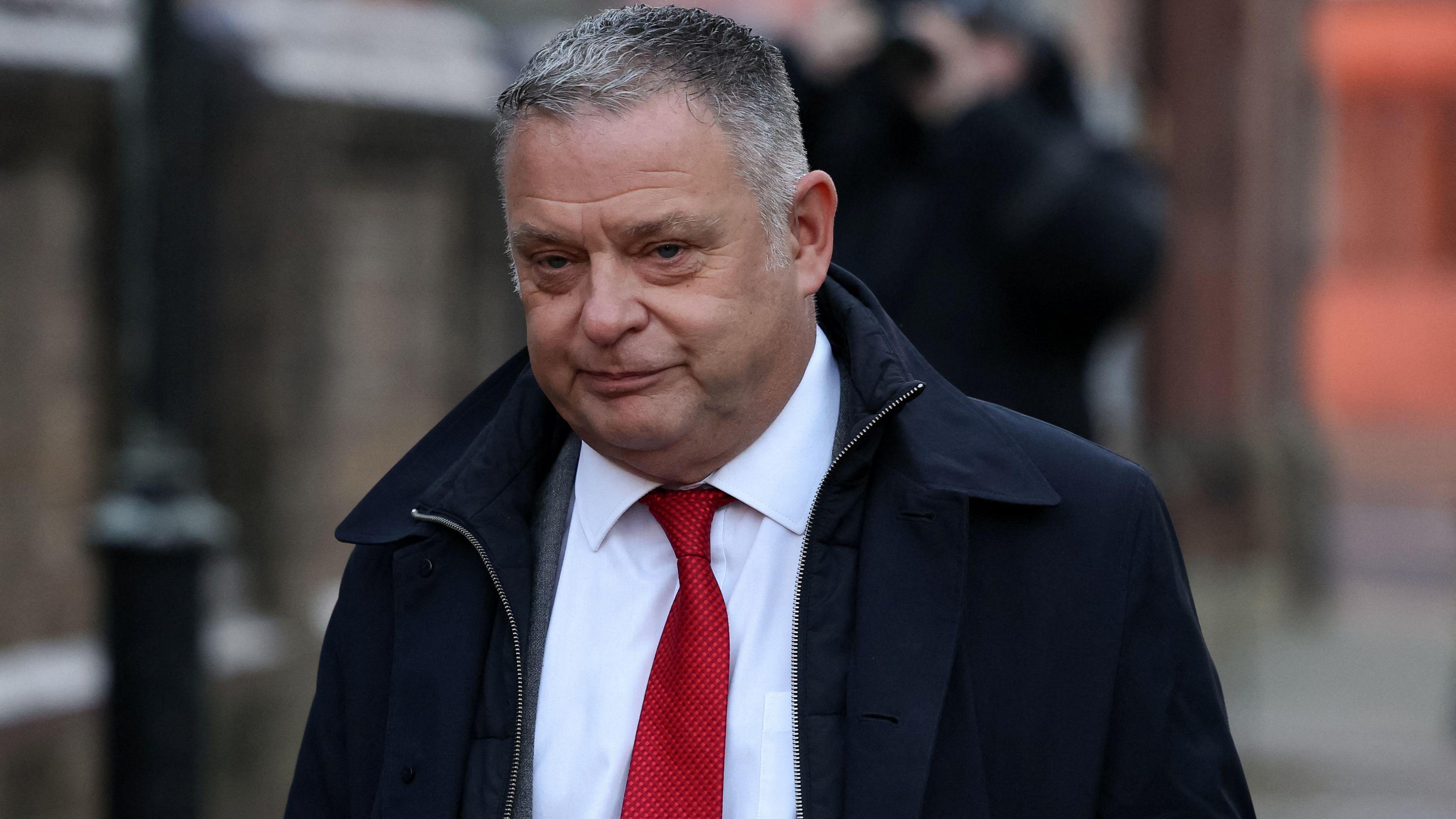 Mike Amesbury, wearing a dark suit, red tie and white shirt, arrives at court in January, where he admitted a charge of assault.