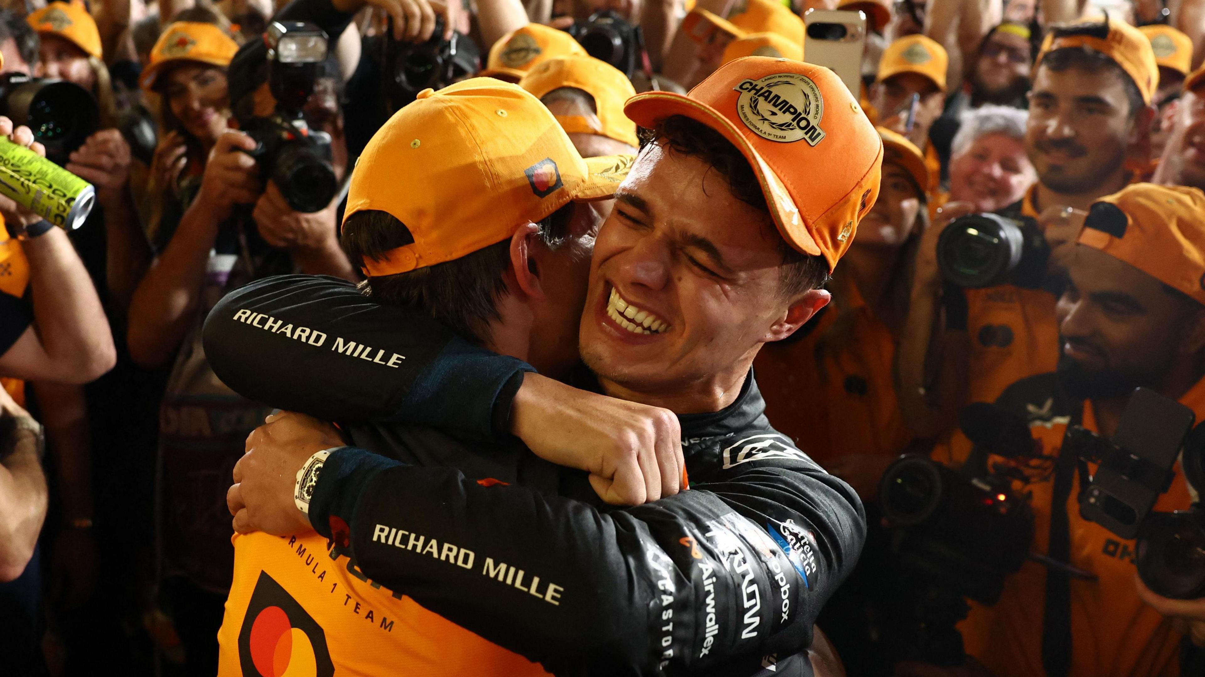 Lando Norris celebrating with McLaren after winning his first world championship 