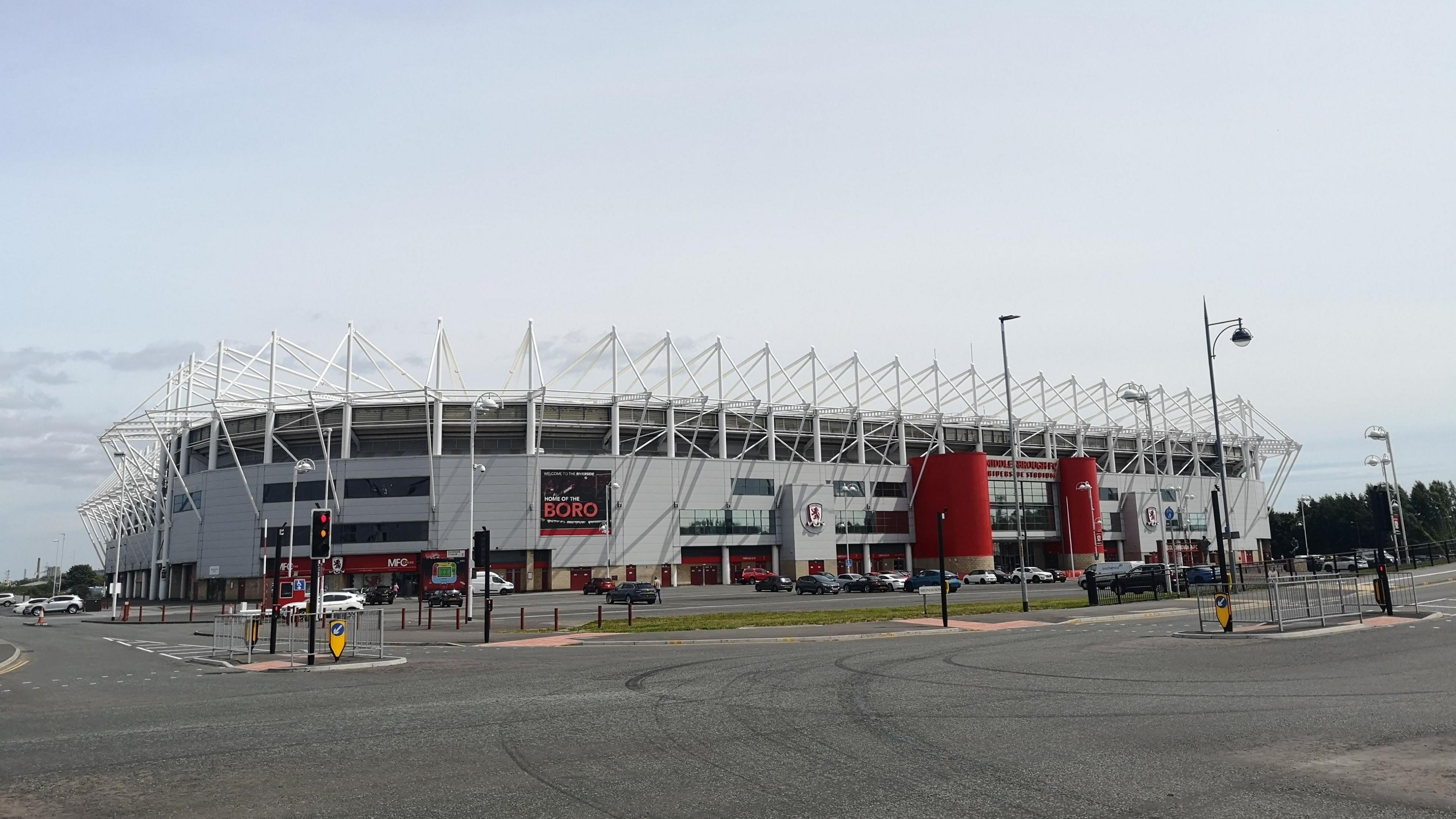 Outside of football stadium with an empty road in the foreground