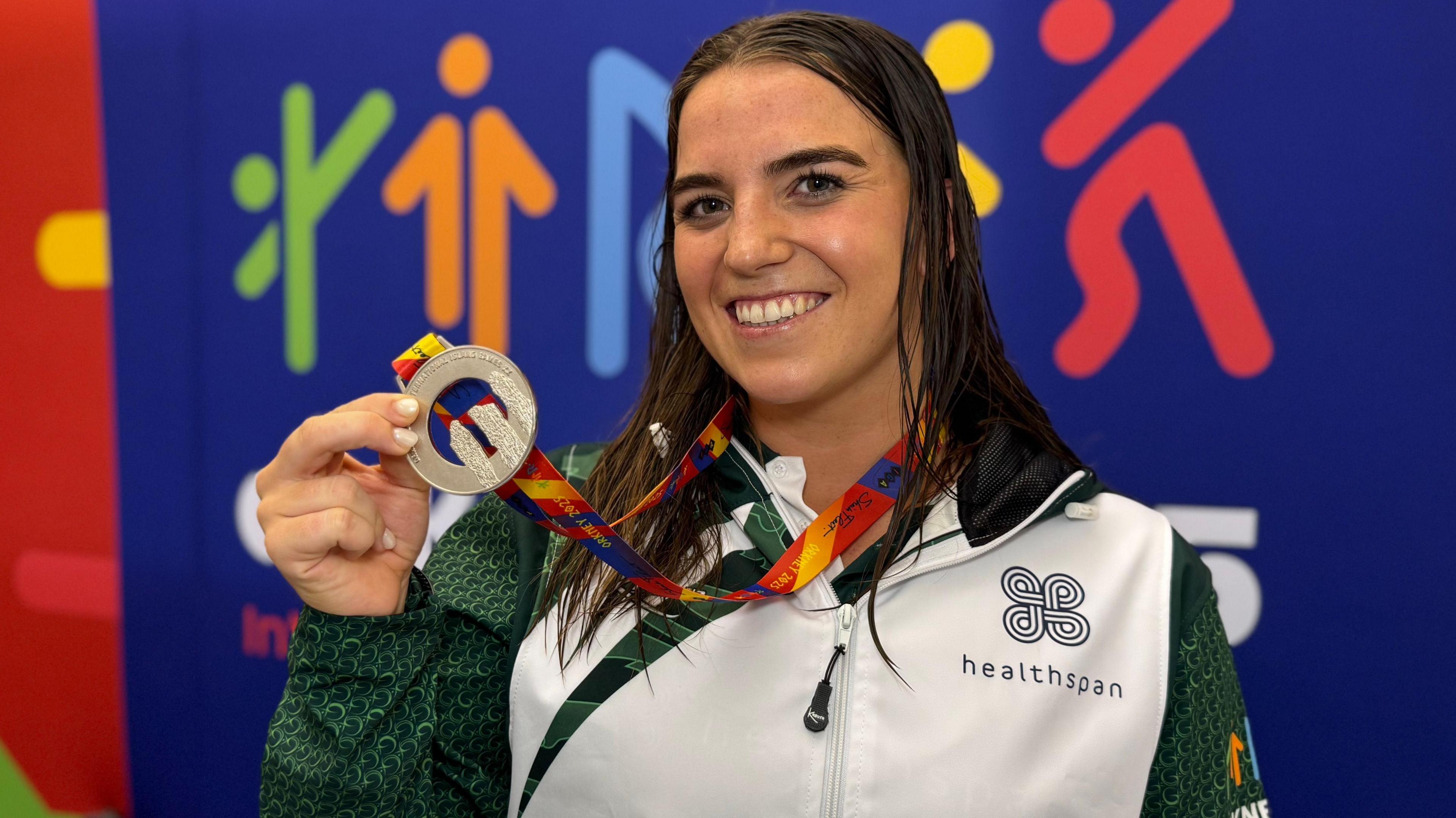 Orla Rabey poses with a medal
