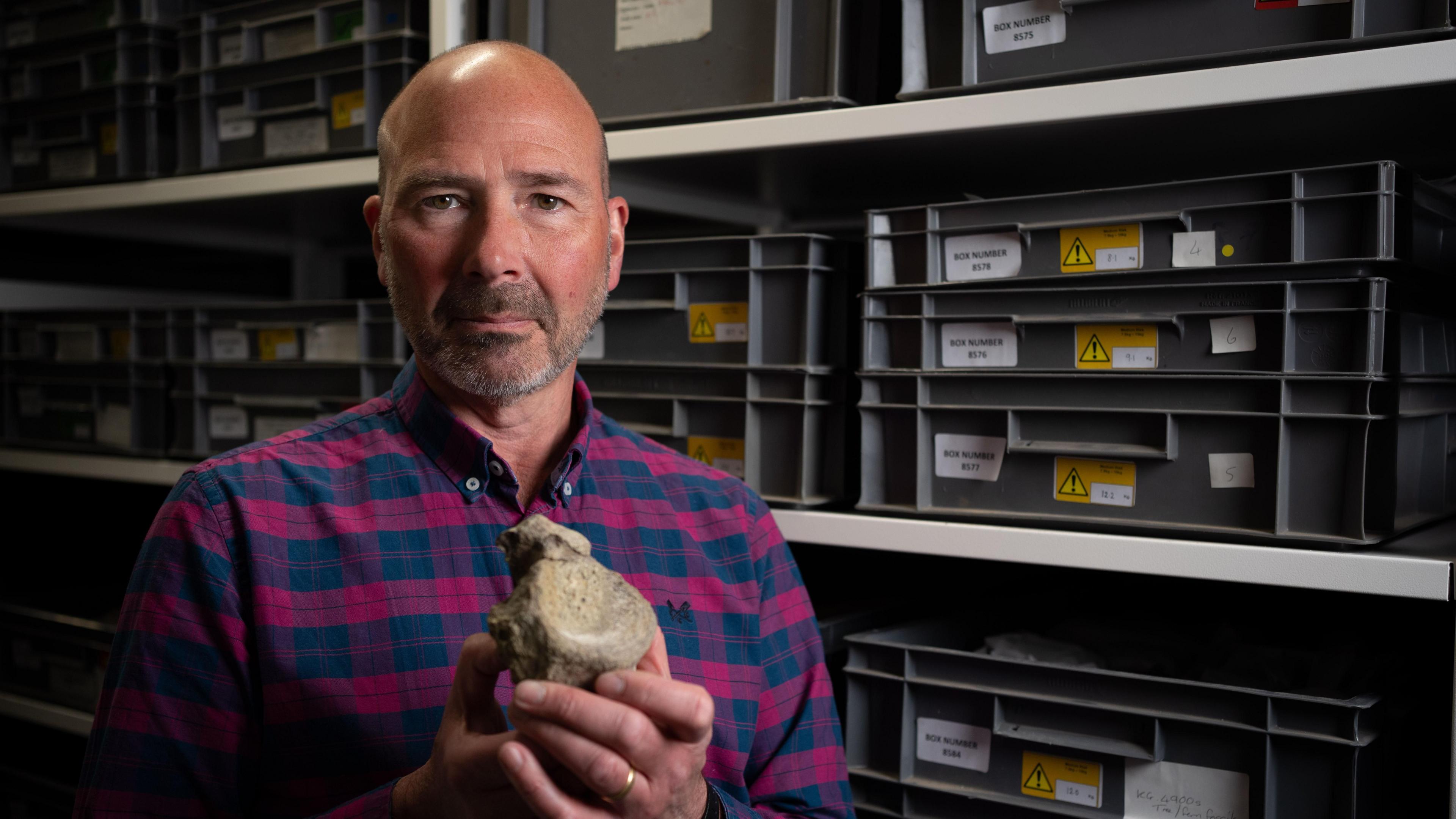 Mark holds the fossil 