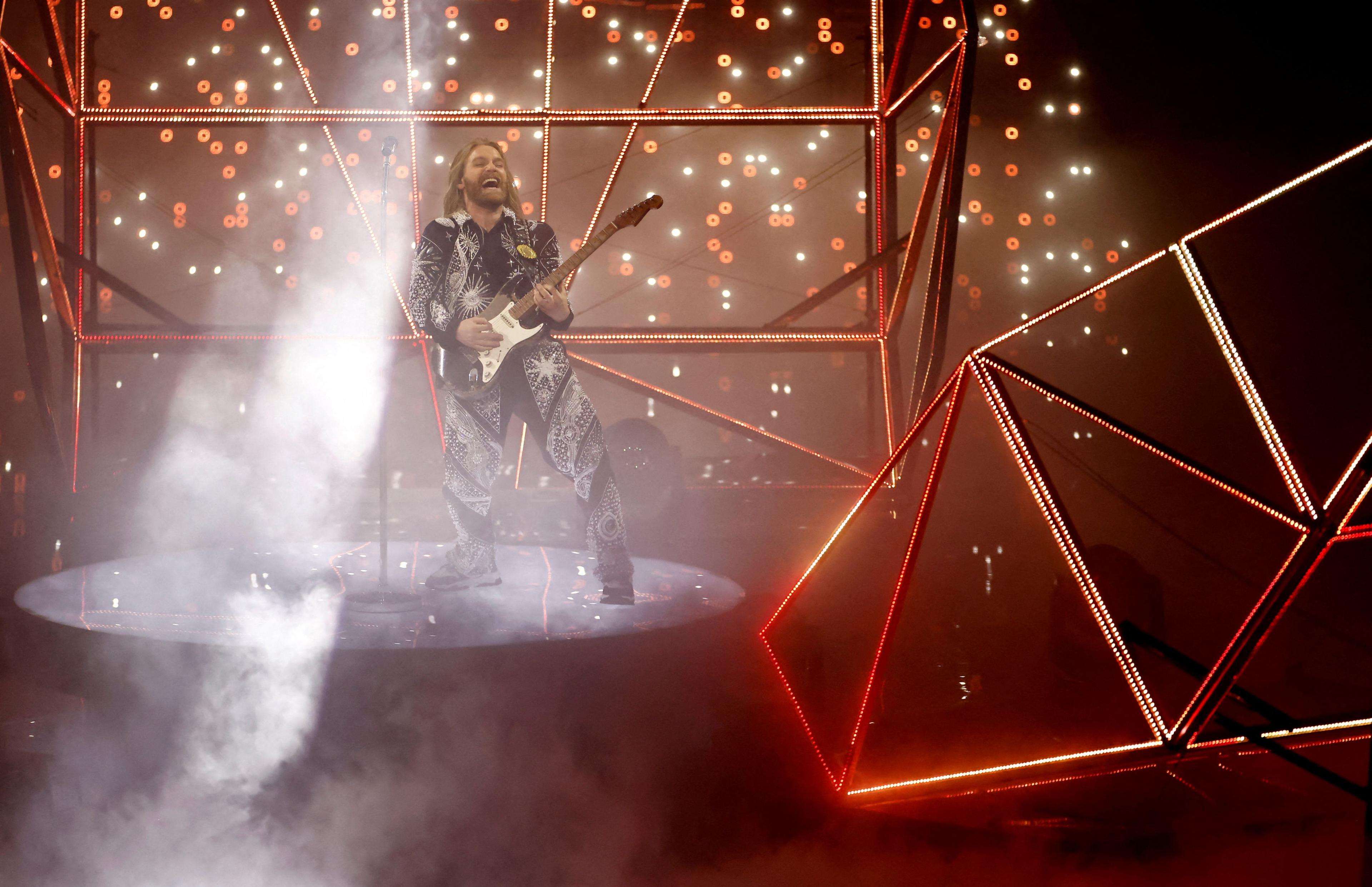 Sam Ryder plays guitar at the 2022 Eurovision Song Contest