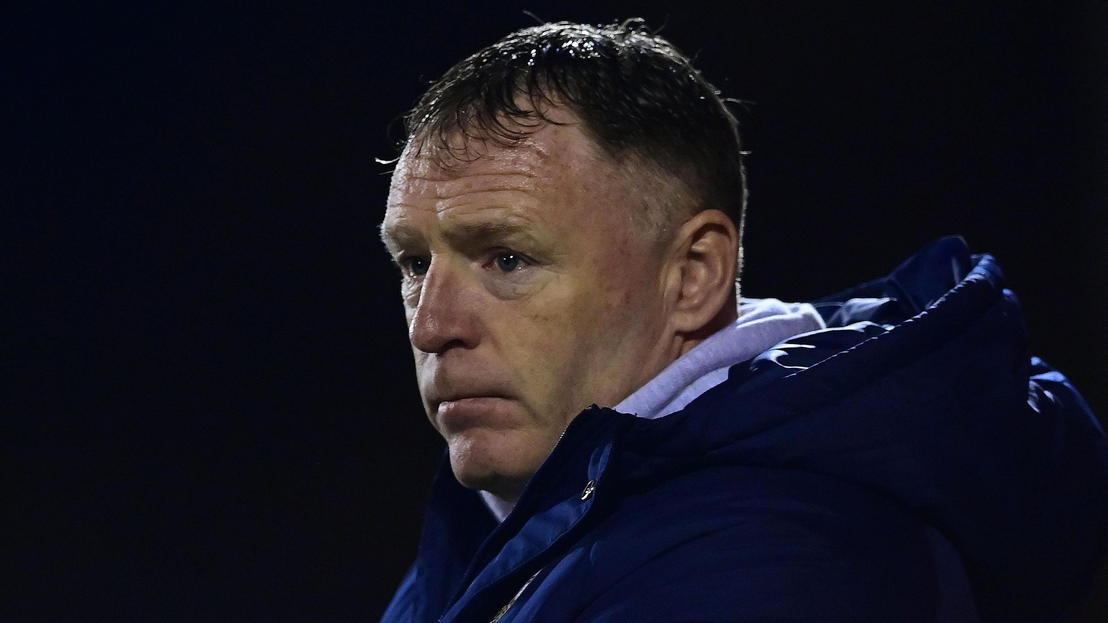 Graham Coughlan, in blue hooded jacket, stares intently